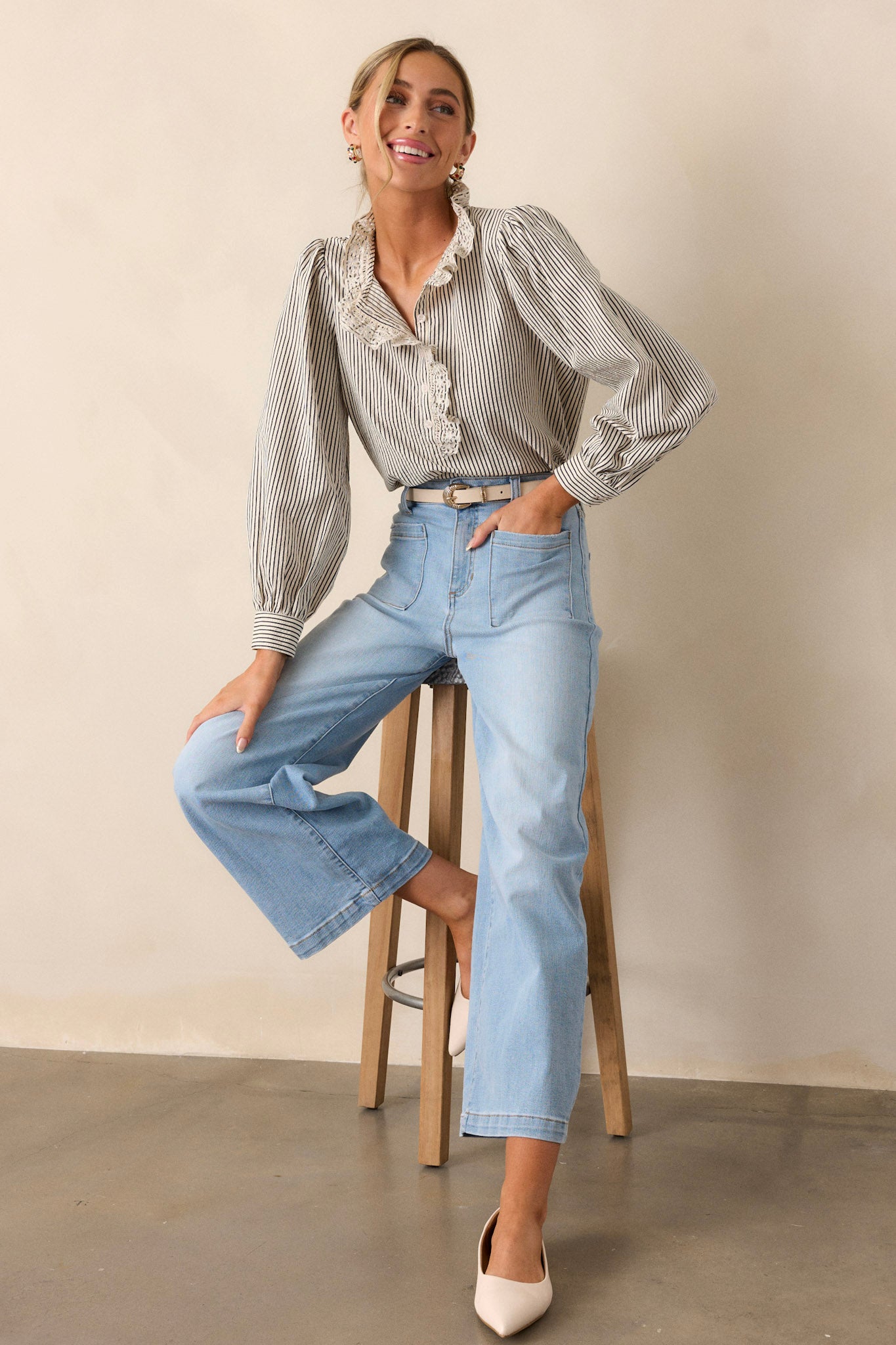 Side view of wide leg jeans showcasing the functional belt loops, button zipper closure, functional front and back pockets, and wide leg design.