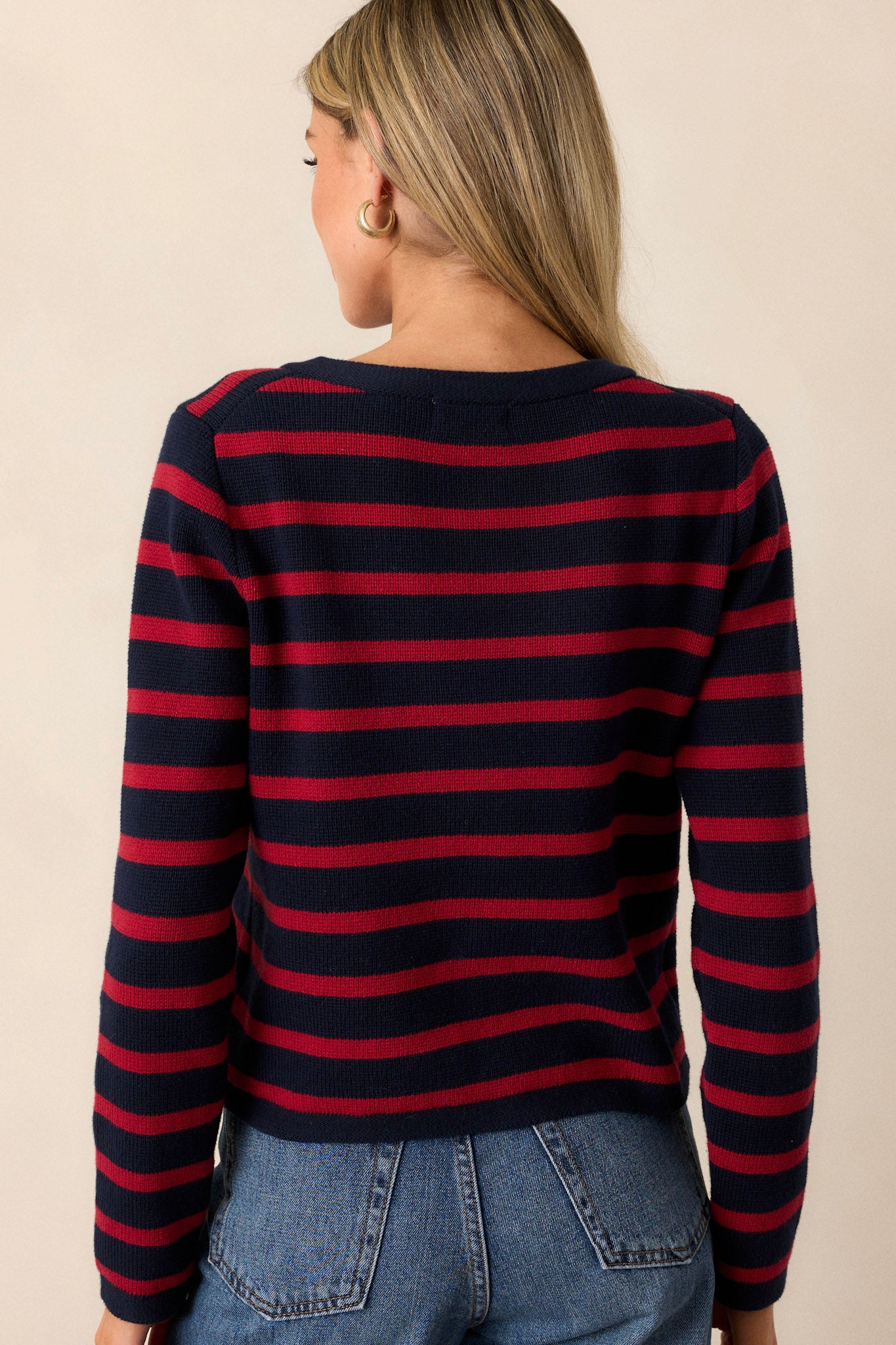 Back view of a cardigan highlighting the overall fit and design, along with the crew neckline and long sleeves.