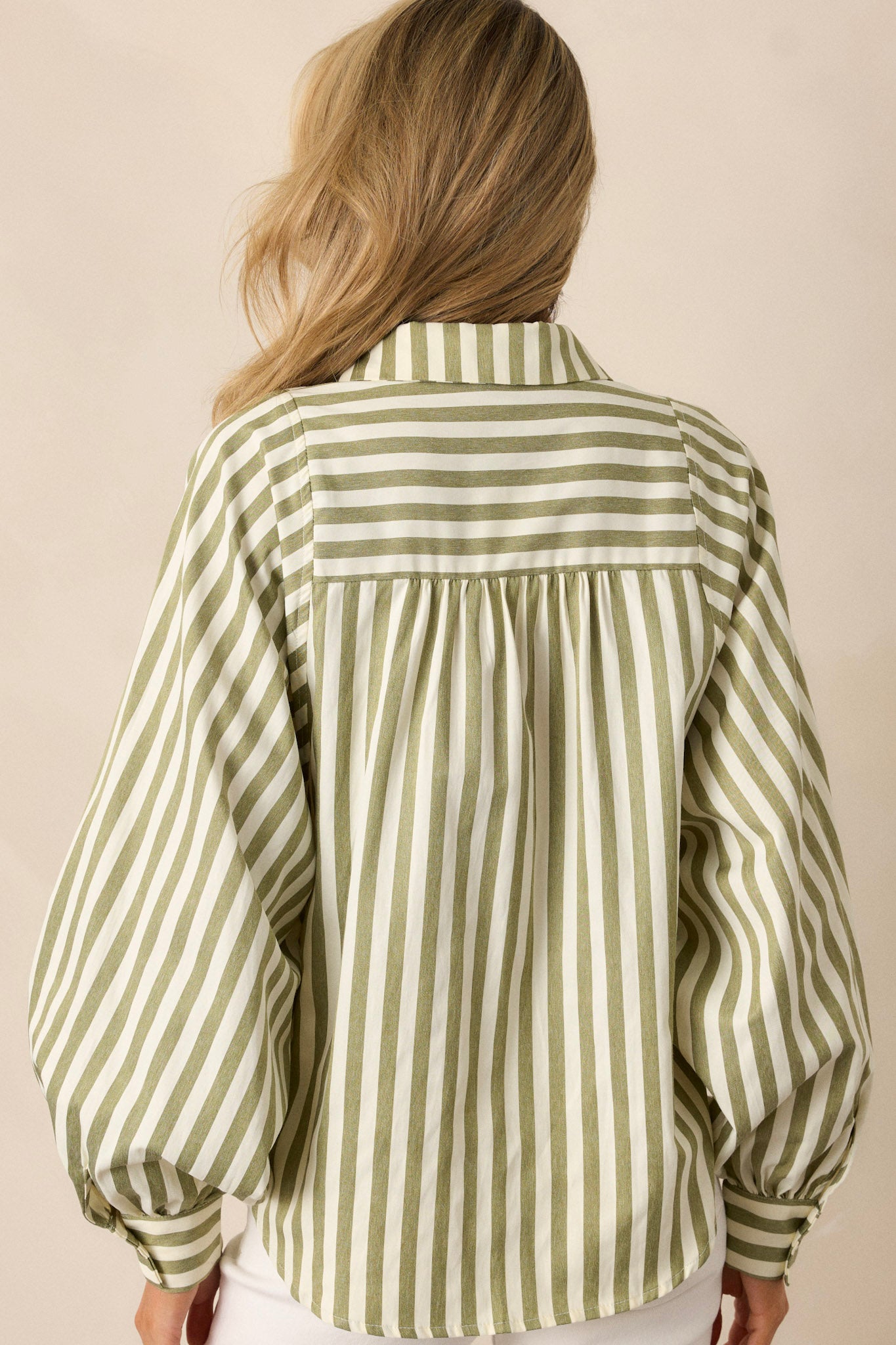 Back view of an olive green stripe top highlighting the vertical green and white stripe design, relaxed fit, and overall back detailing.