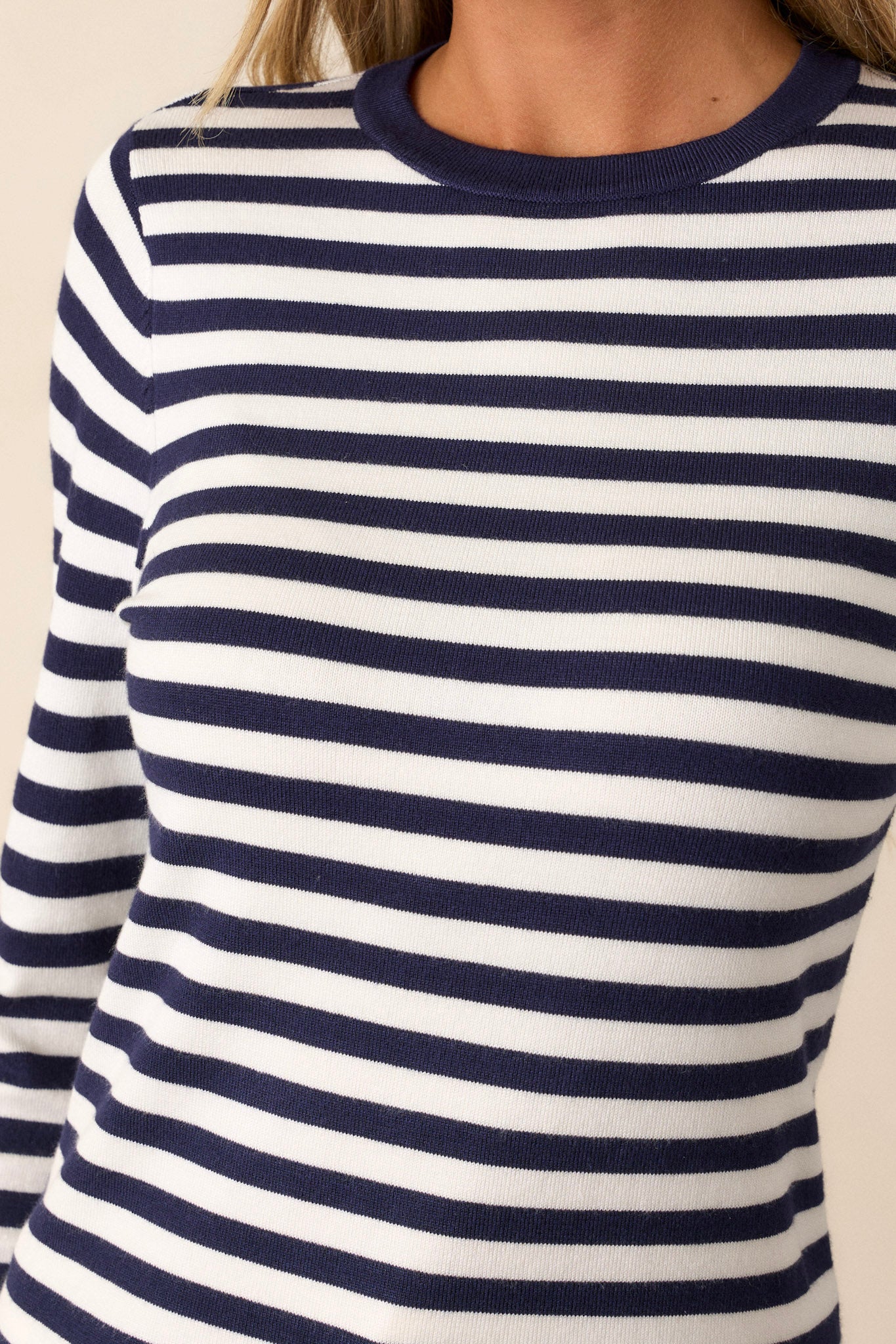 Close up of the navy stripe pattern on this long sleeve, ivory top. 