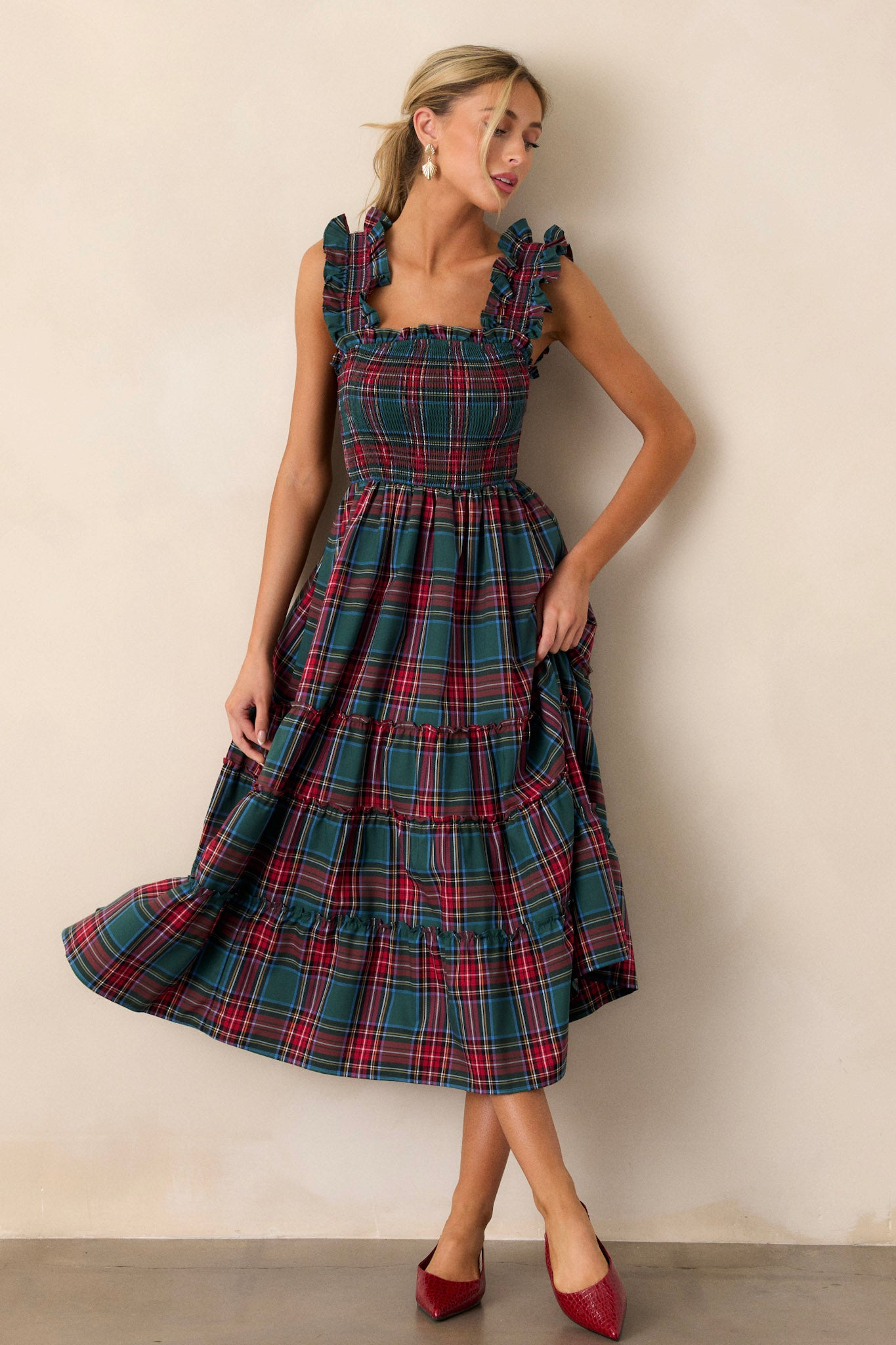 Front view of this dress that features thick ruffle straps, smocked bodice, and a tiered skirt.