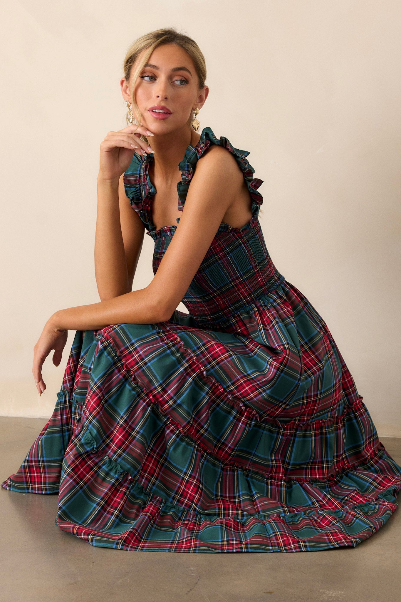 This green dress features thick ruffle straps, smocked bodice, and a tiered skirt. 