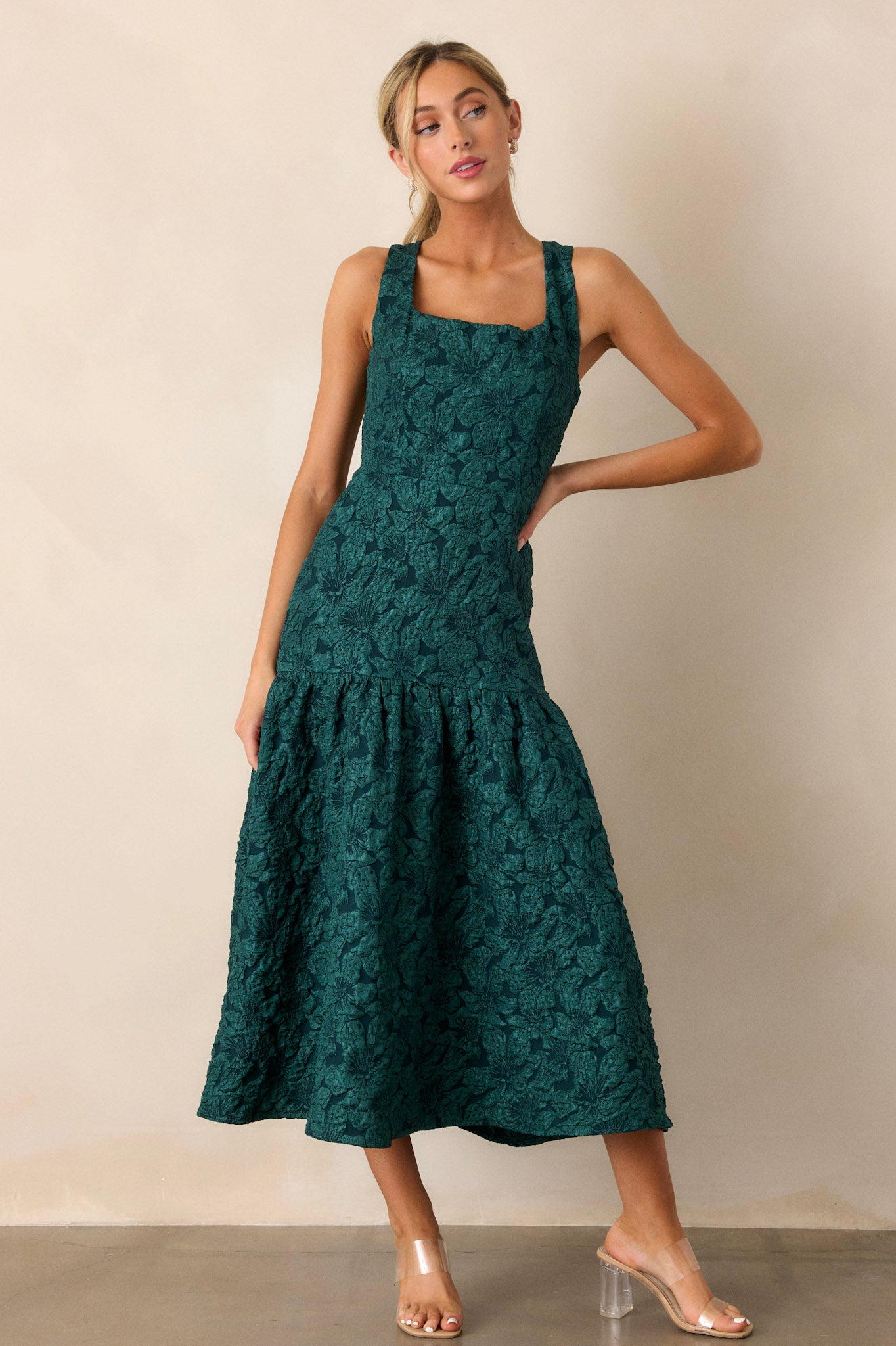 Full-body image showcasing the green dress’s top, emphasizing the sleeveless cut, square neckline, and the intricate jacquard detailing.