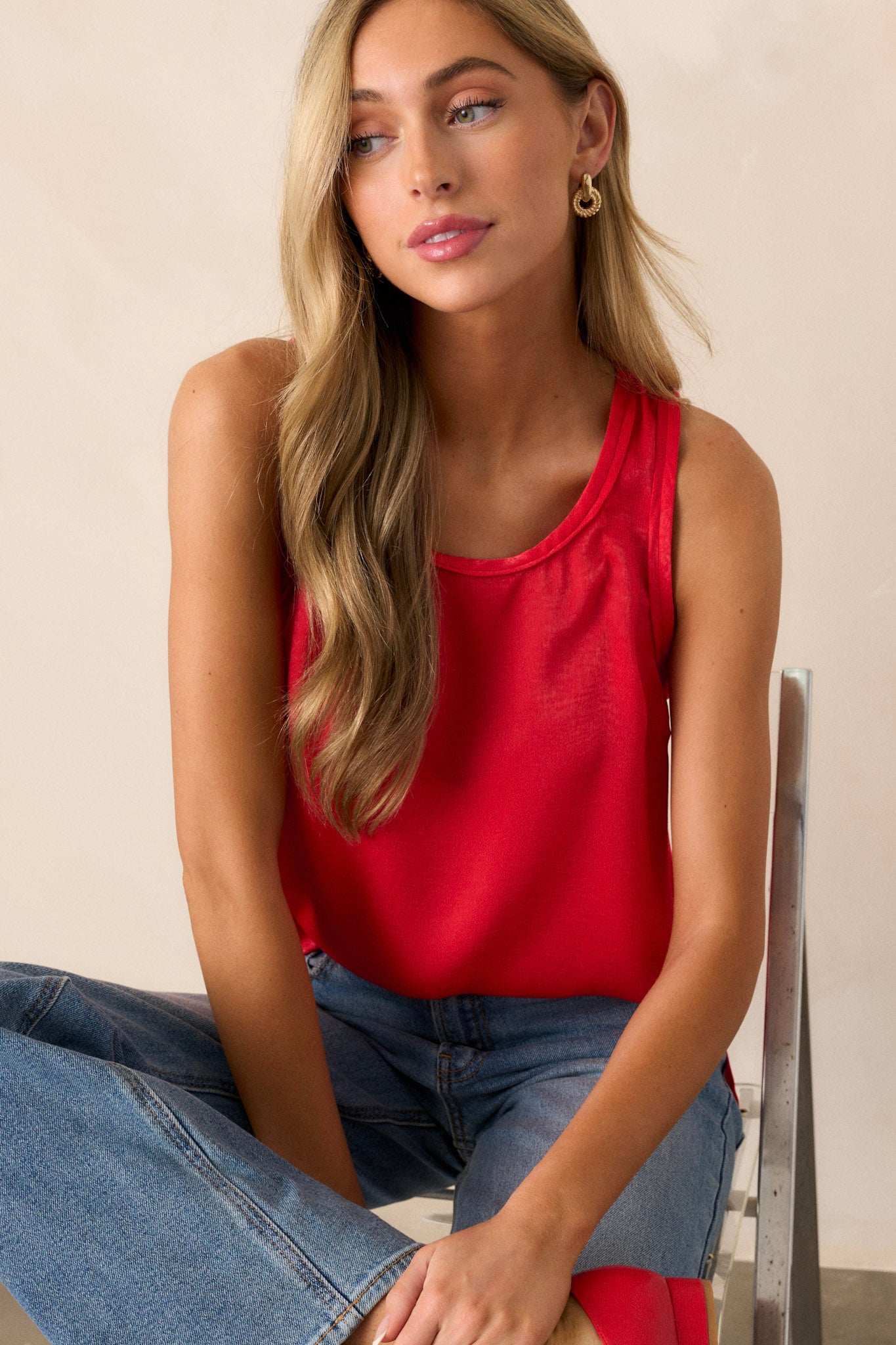 Front view of a tank top featuring a scoop neckline, slits up the sides of the bottom hem, and a lightweight fabric.