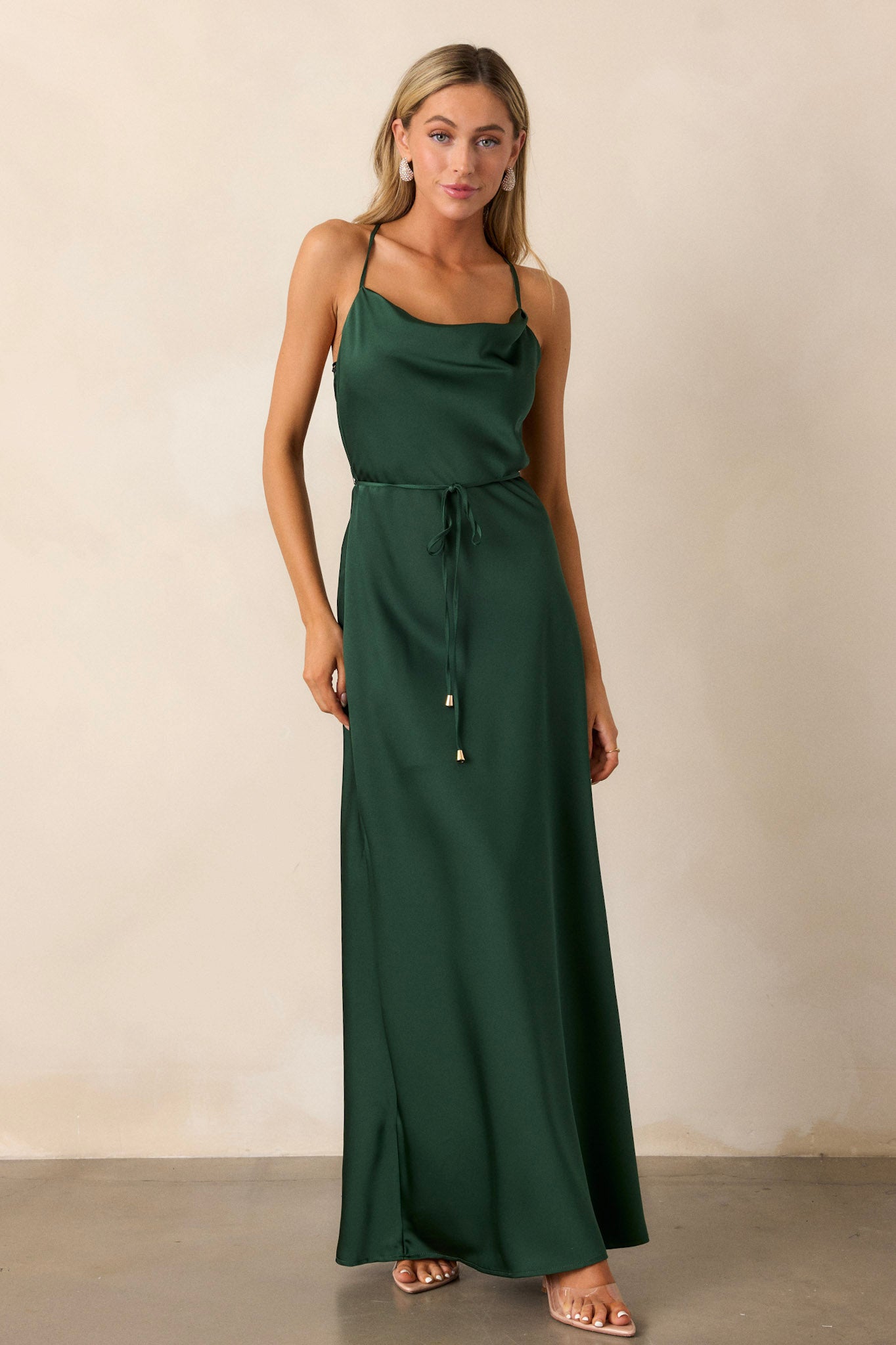 Front image of the emerald dress, showcasing the cowl neckline, adjustable straps, and the soft drape of the satin fabric across the chest.