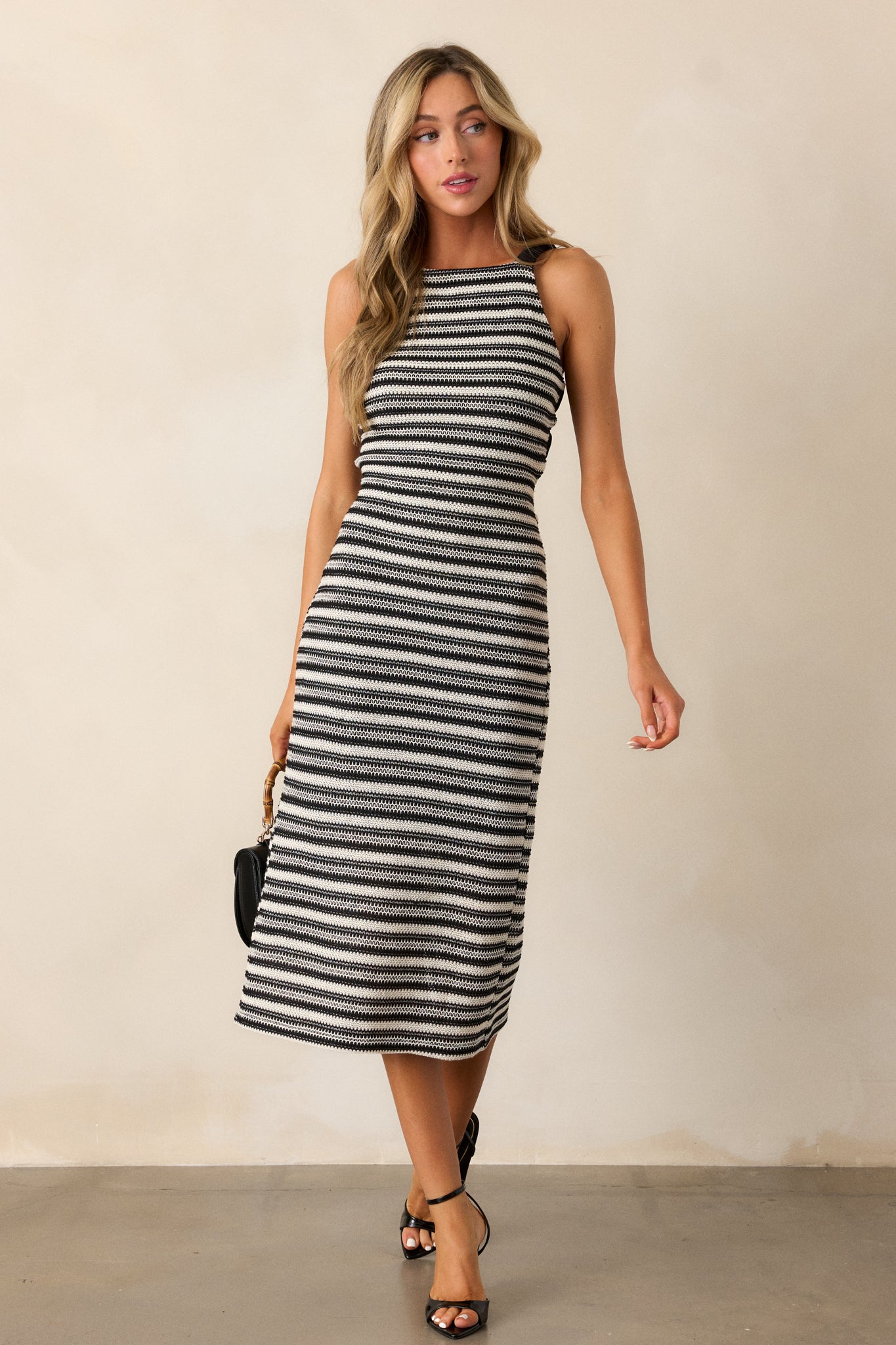 Full-length shot focusing on the gorgeous knit design and texture of the dress, with the thick straps and stripes clearly visible.