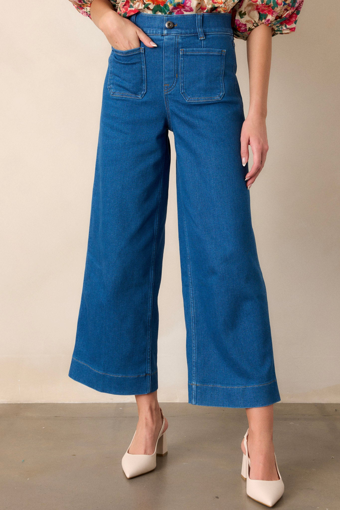 Front angled view of these jeans that feature a cropped length, a pull on design, functional belt loops, and two front patch pockets.