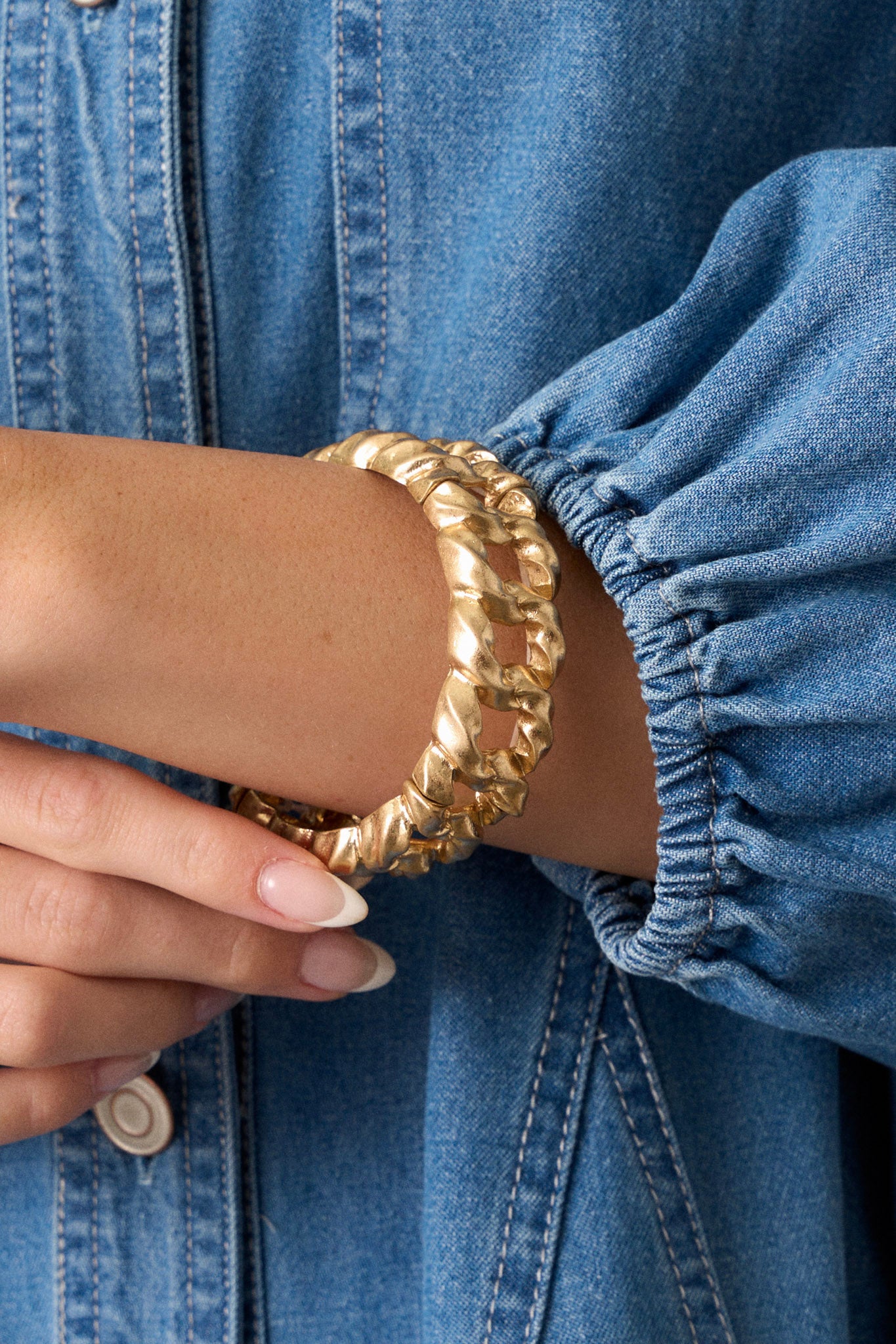 Close up view of this gold chain bracelet features a chain look, elastic bands for stretch as needed and split design.