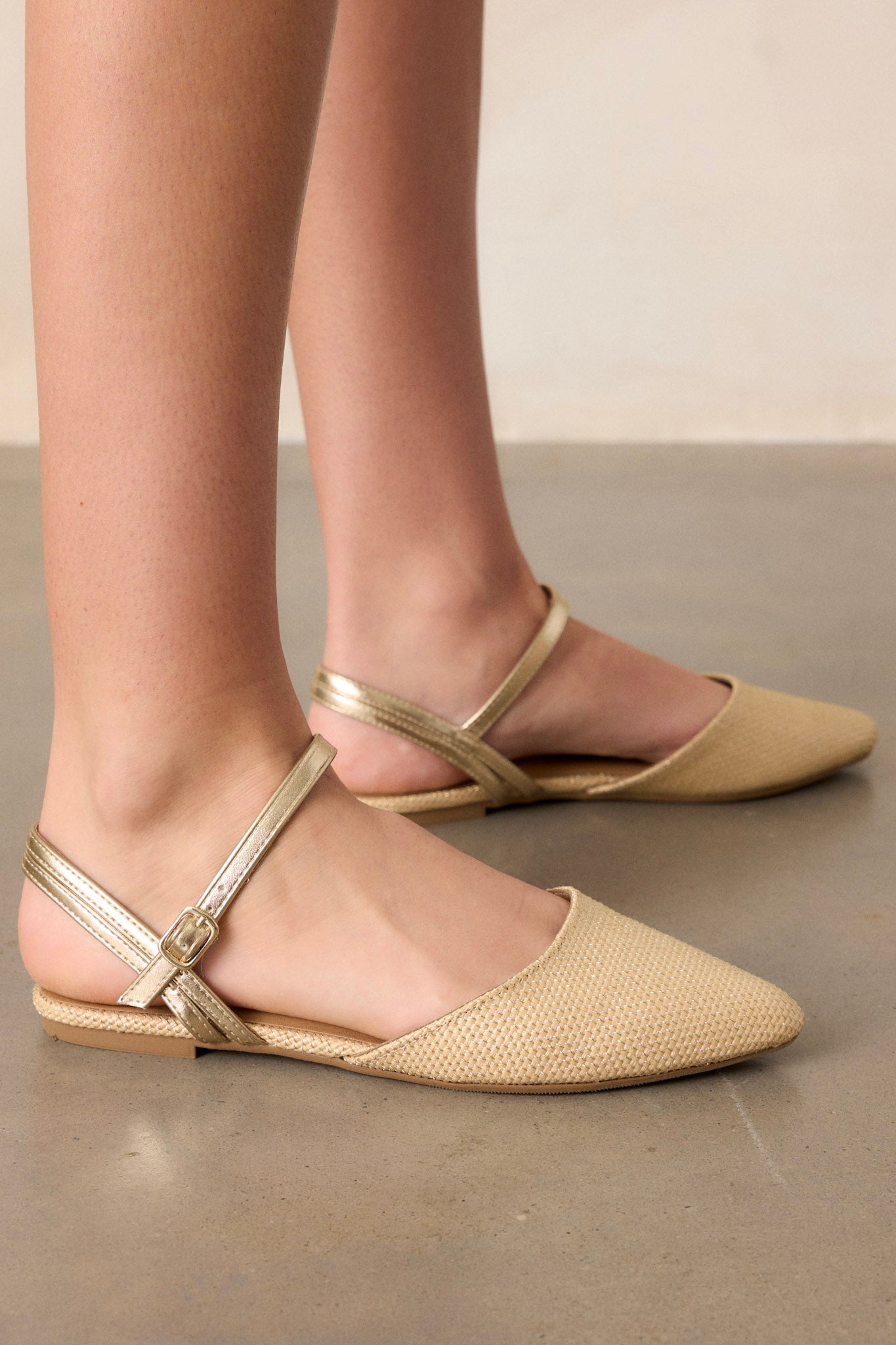 These beige flats feature braided gold detailing, a gold adjustable ankle strap and a cushioned sole.