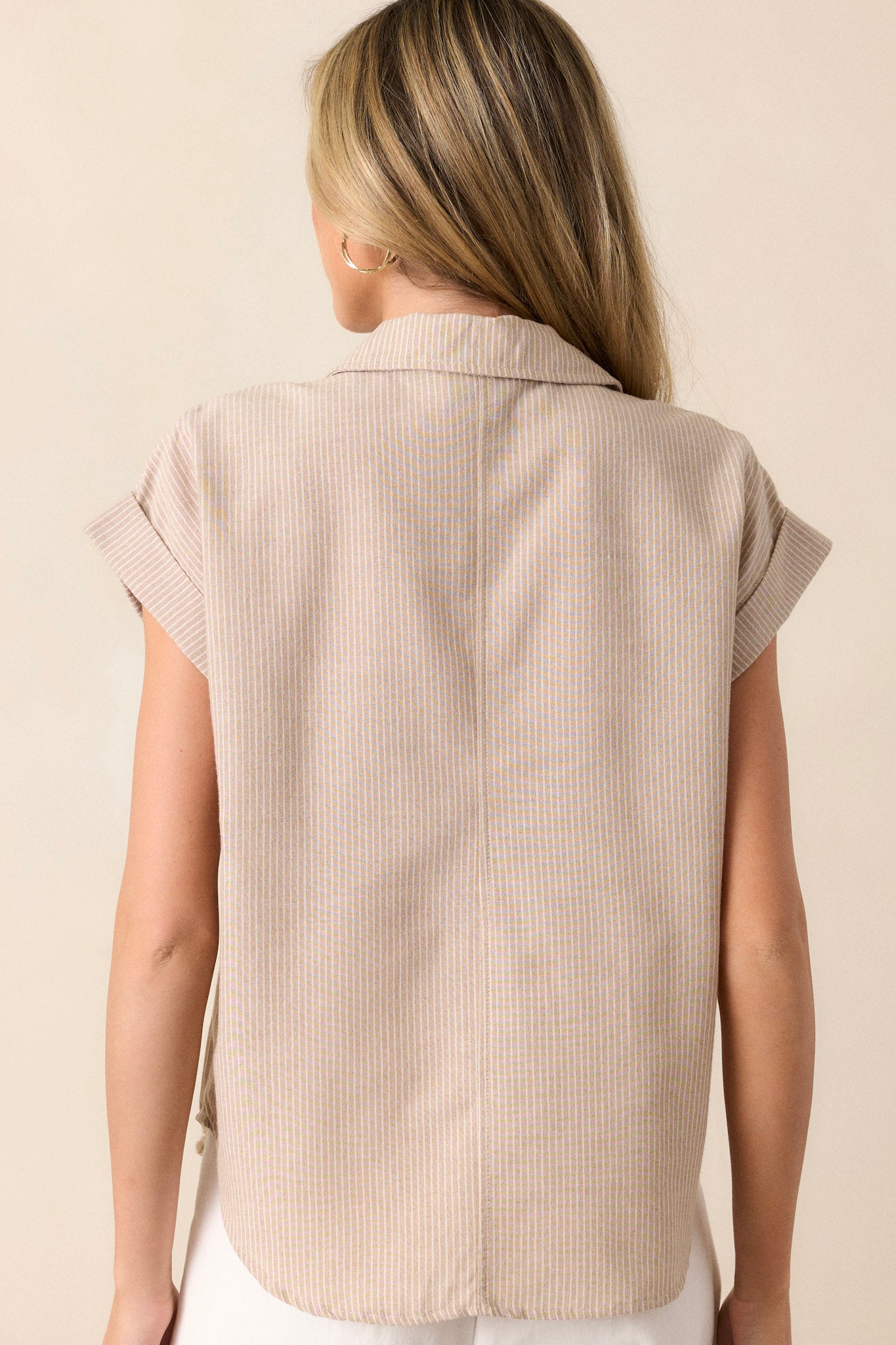 Back view of this taupe stripe top that features a collared v-neckline, a functional button front, a vertical stripe pattern, functional bust pockets and short sleeves.