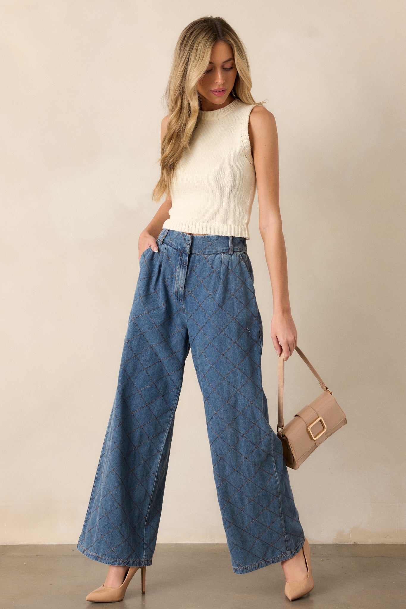 These quilted jeans features a high waisted design, a hook and bar closure, functional belt loops, hip pockets, a quilted design and a wide leg.