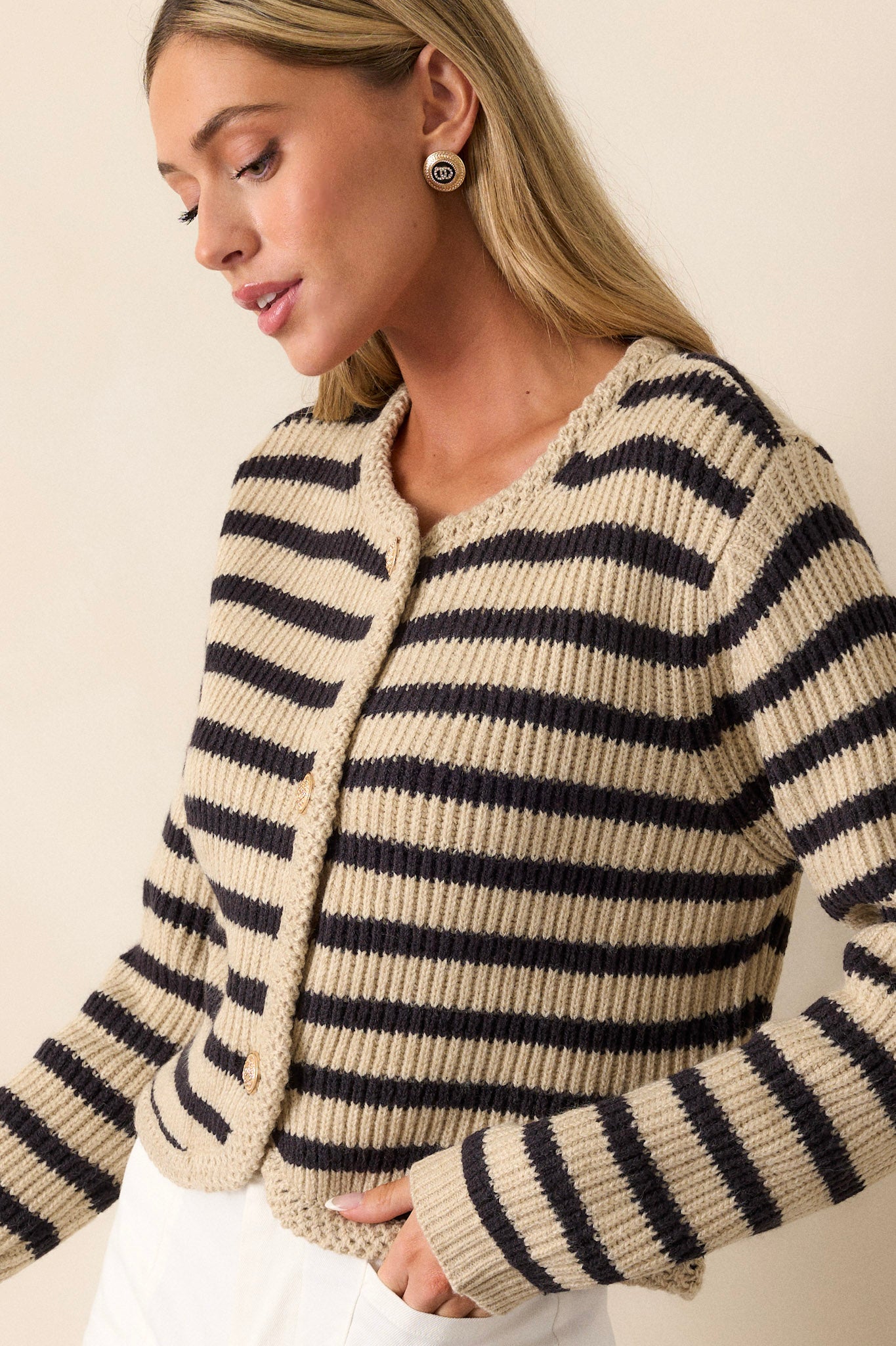 Close-up view of the top portion, focusing on the rounded braided knit neckline and black and tan stripe pattern.