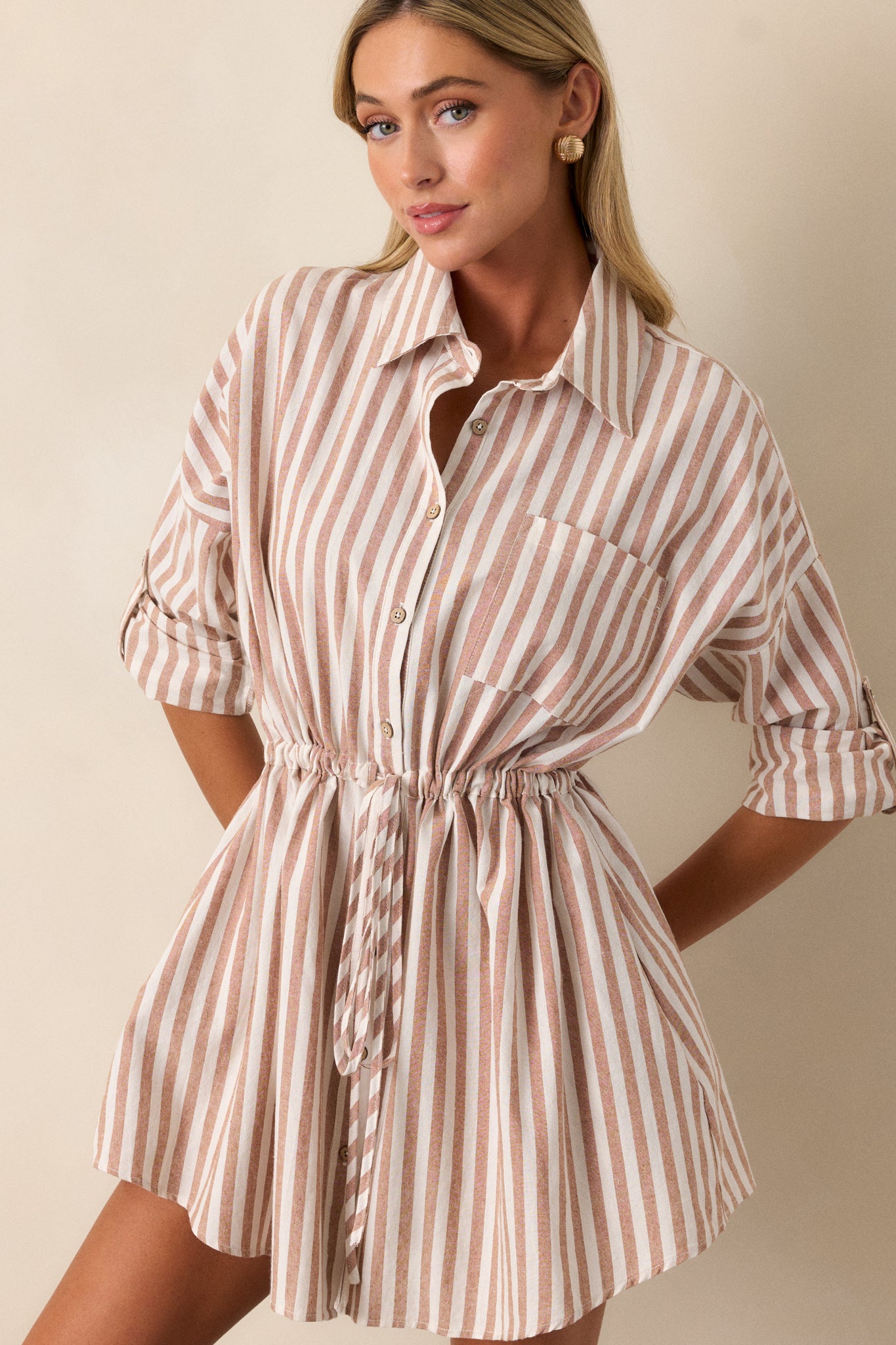 Cropped image of the sleeve, highlighting the button cuff detail and how it complements the stripe pattern.