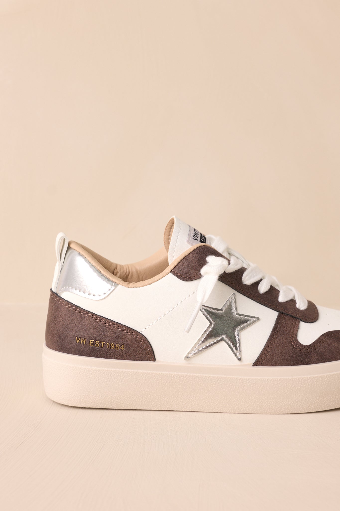 Close-up of the sneaker’s silver star detailing, focusing on the texture and craftsmanship of the shoe.