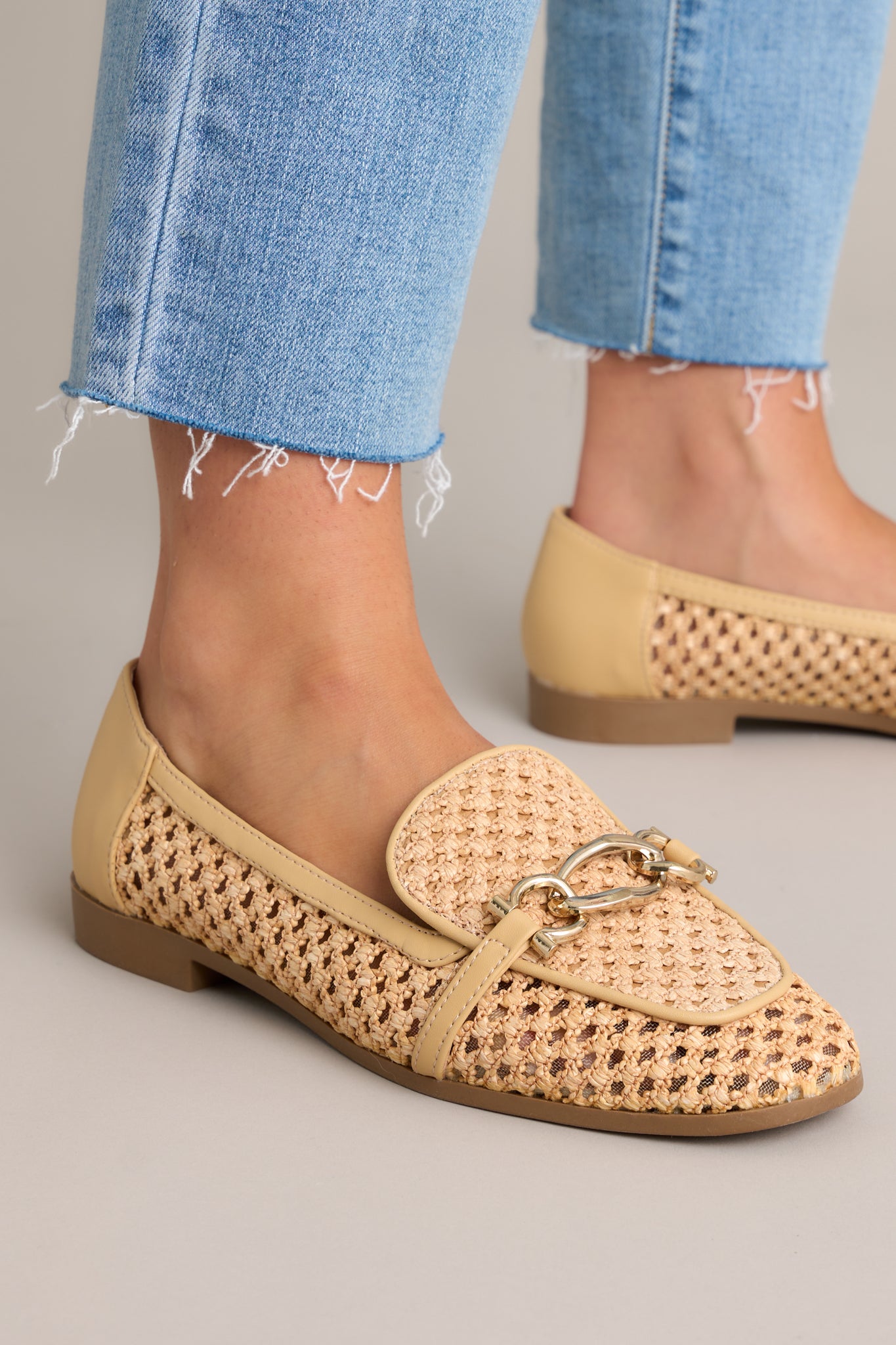 These woven loafers feature a rounded toe, gold accented strap, a breathable woven material and tan color blocking.