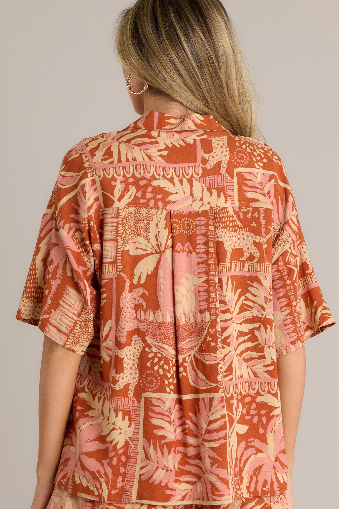 Back view of a sienna rose top highlighting the relaxed fit, short sleeves, and overall design.