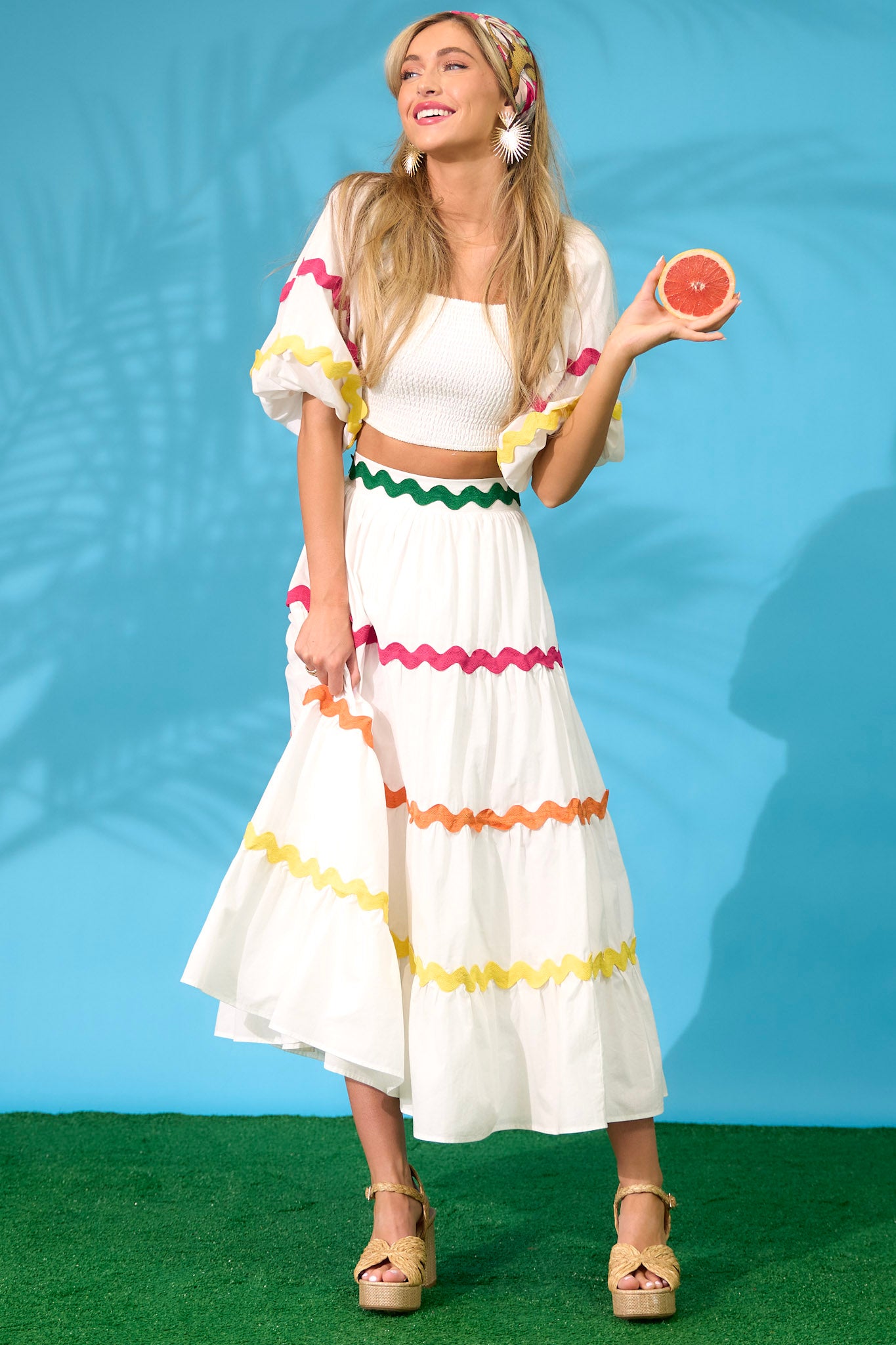 Model posing candidly in this white maxi skirt features a high waist, a side zipper closure, and a flowed out skirt style.