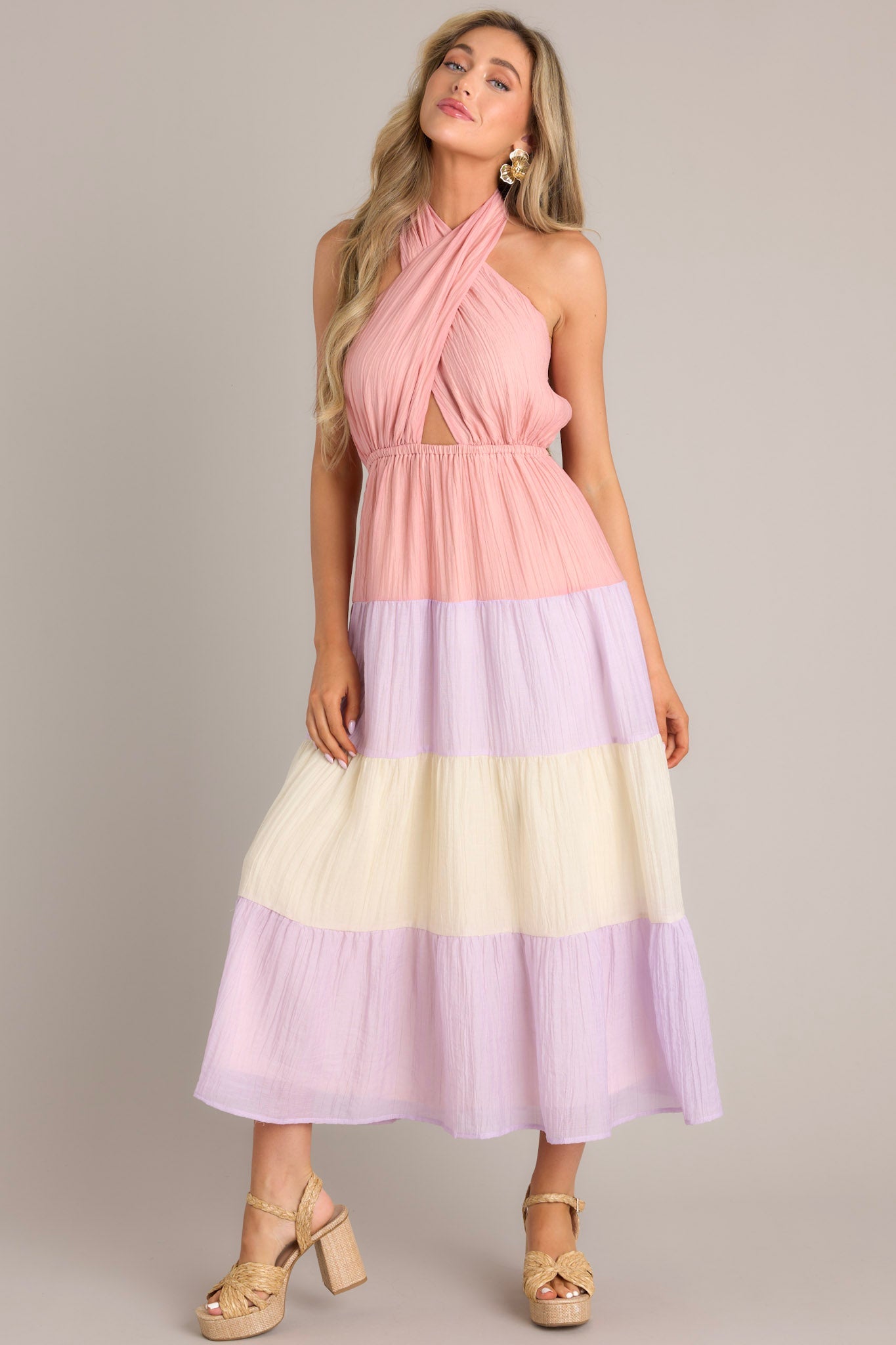 Effortlessly chic dress featuring a self-tie halter neckline with a back tie closure, an alluring open back, and an elastic band at the back of the bust for a comfortable fit. Complete with an elastic waistband and a flowing skirt for a flattering silhouette.