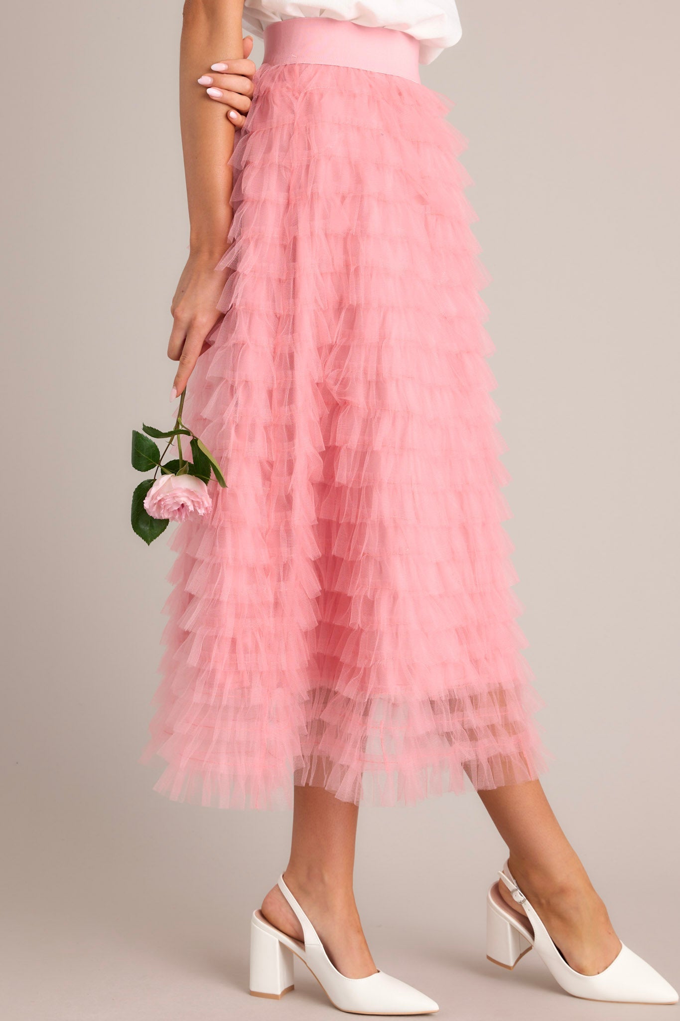 This skirt features a high waist design, an elastic waistband and ruffle tulle detailing throughout.