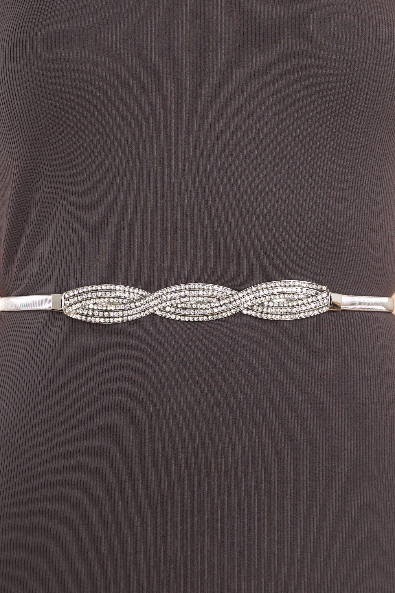 Close up view of this belt that features a rhinestone buckle with a hook and eye closures.