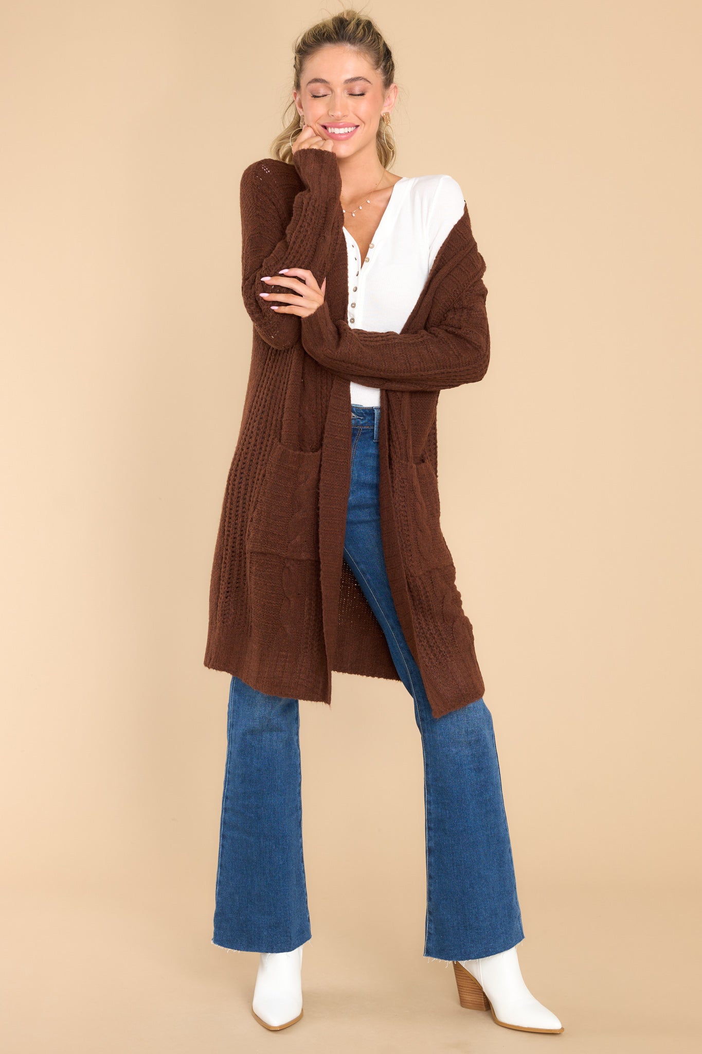 Full body view of this cardigan that features an open-front design, long sleeves with tapered cuffs, functional pockets, and a soft knit feel throughout.