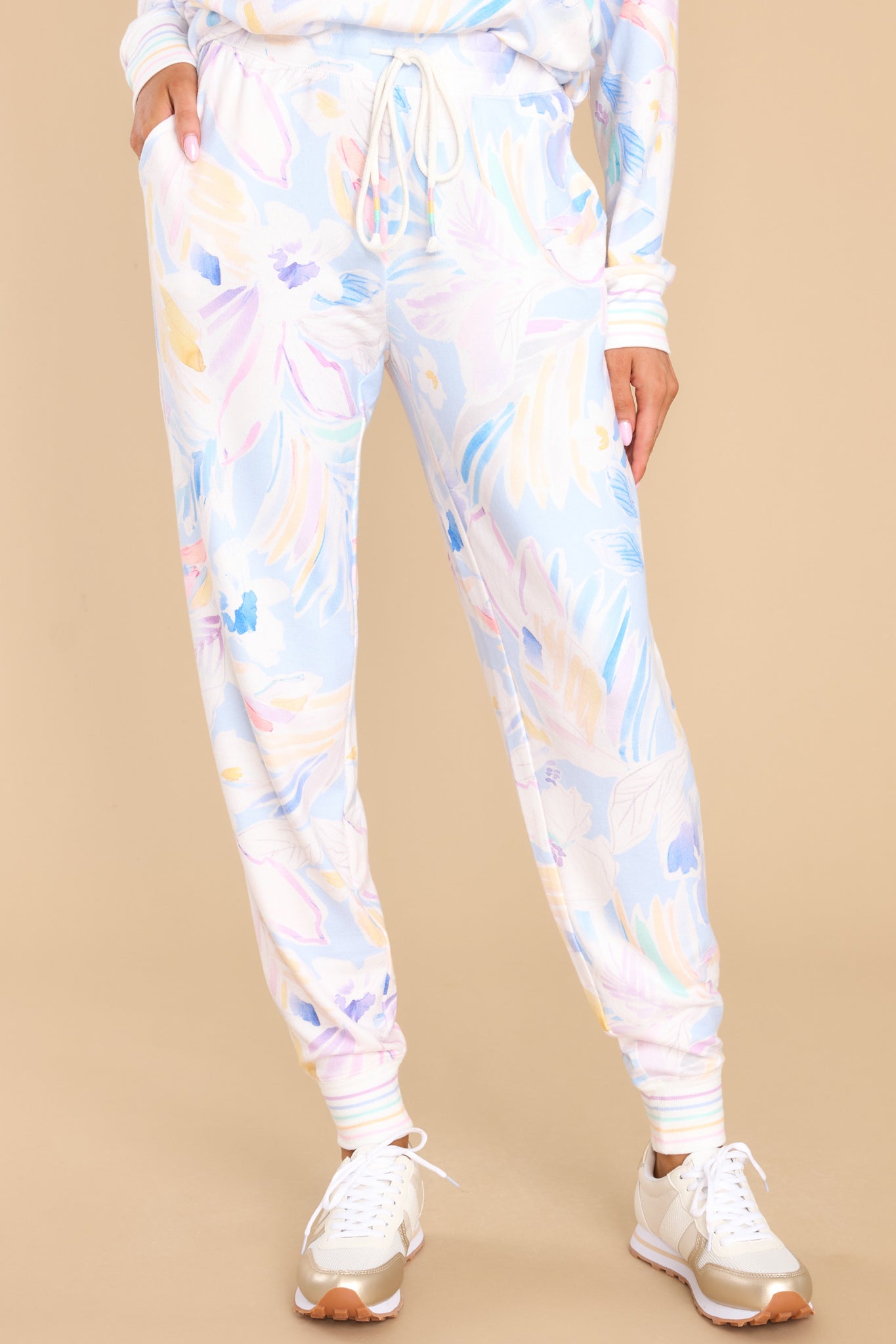 These multi-colored joggers feature a high waist with a self-tie drawstring, functional pockets, and stretchy cuffs at the ankles.