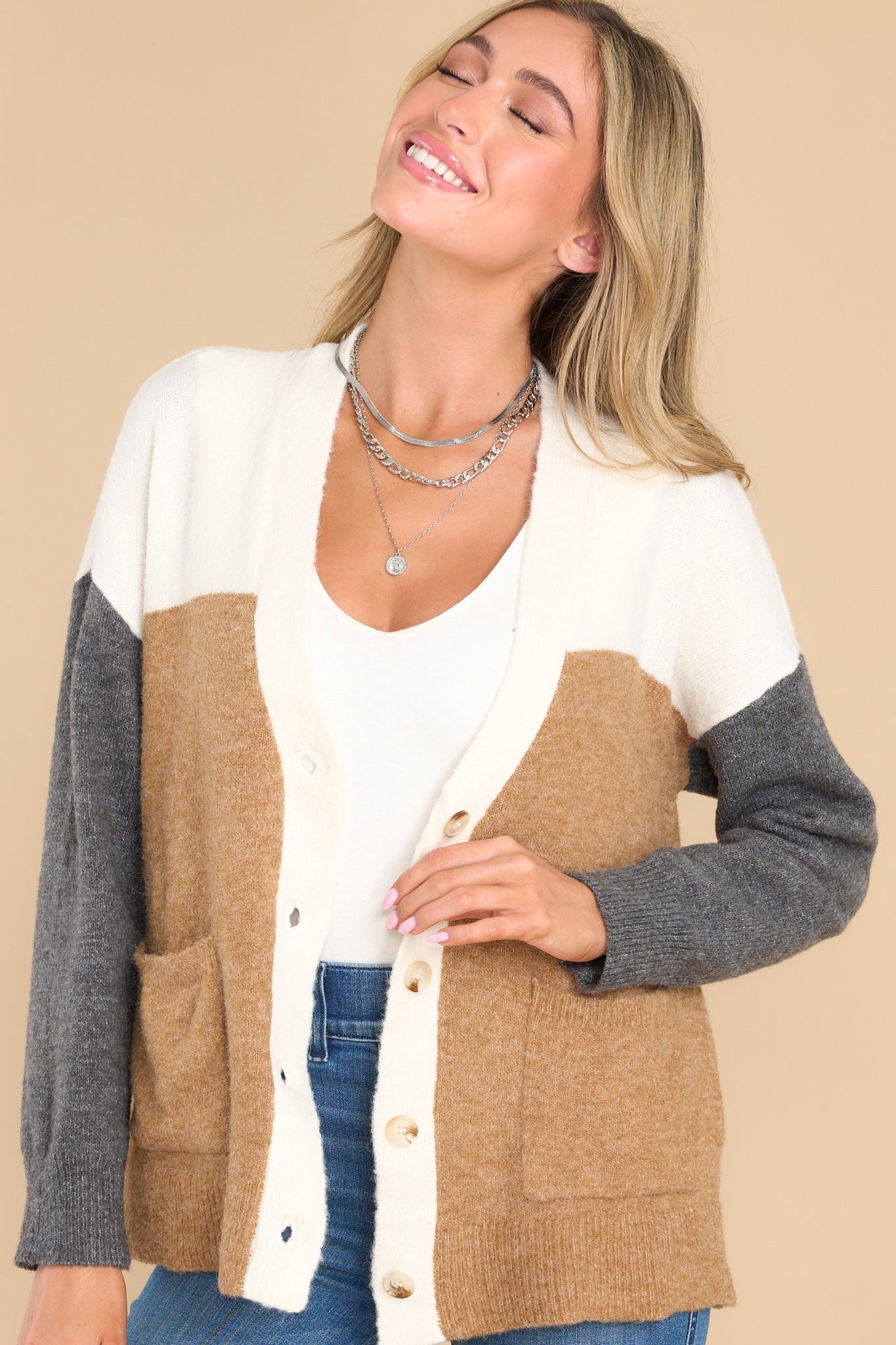 Front view of this cardigan that features a v-neckline with functional buttons down the front, functional pockets, and a soft, wooly feel.