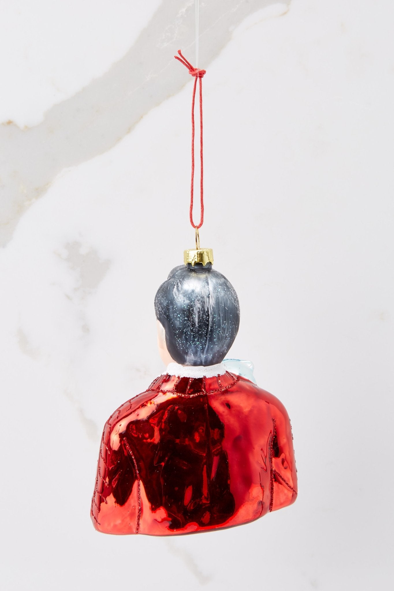 Back view of this ornament that features a design of Mister Rogers with hand painted glitter detailing.