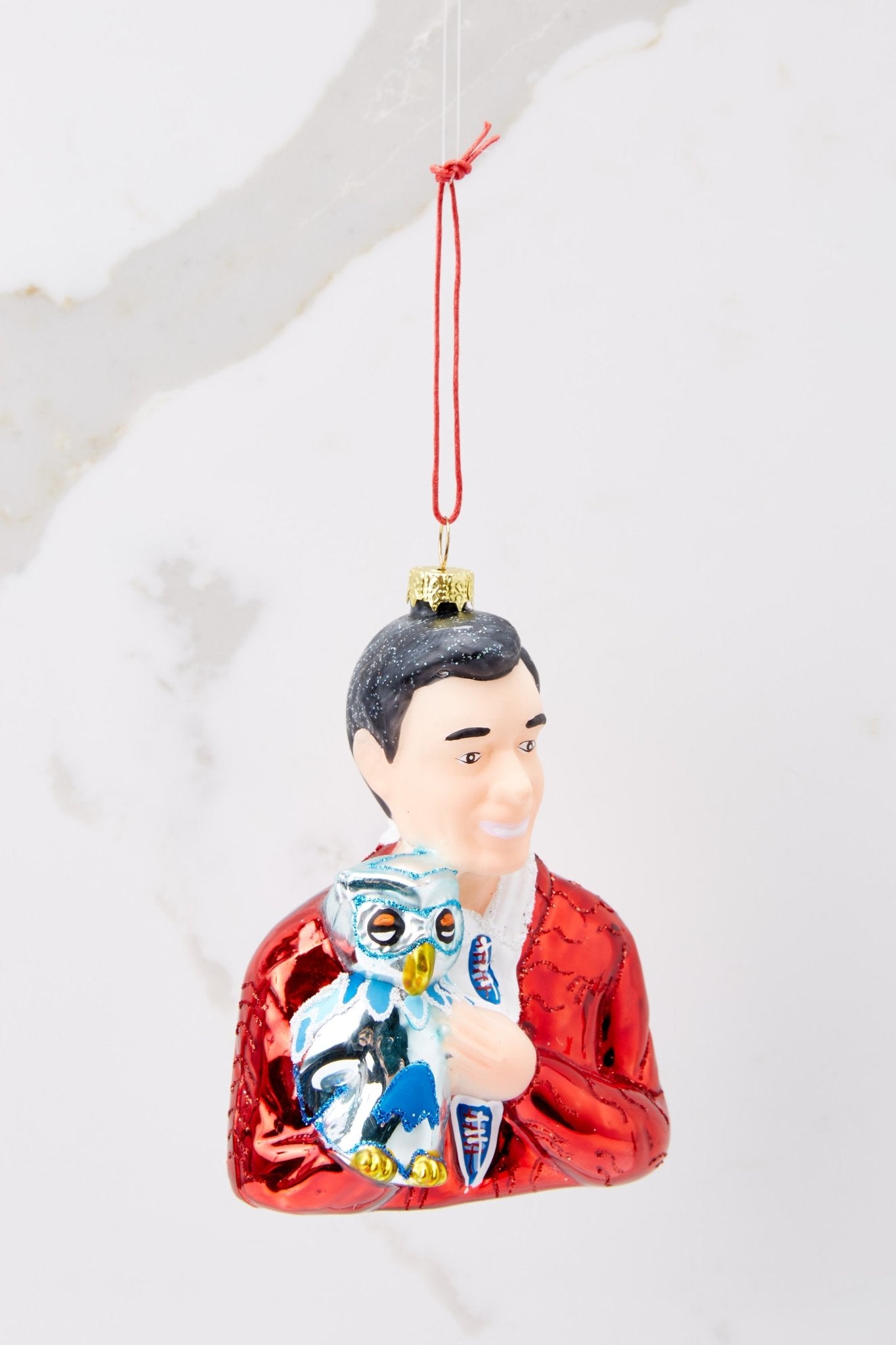 Front view of this ornament that features a design of Mister Rogers with hand painted glitter detailing.