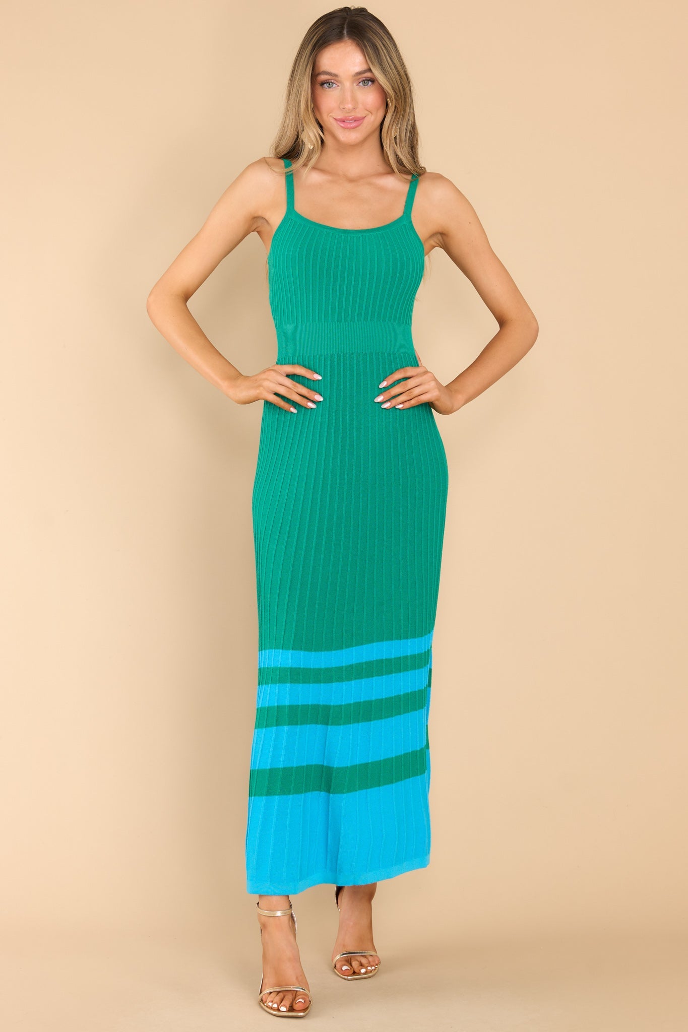 Front view of  this dress that features a scoop neckline, non-adjustable straps, a ribbed texture, and stretch throughout.