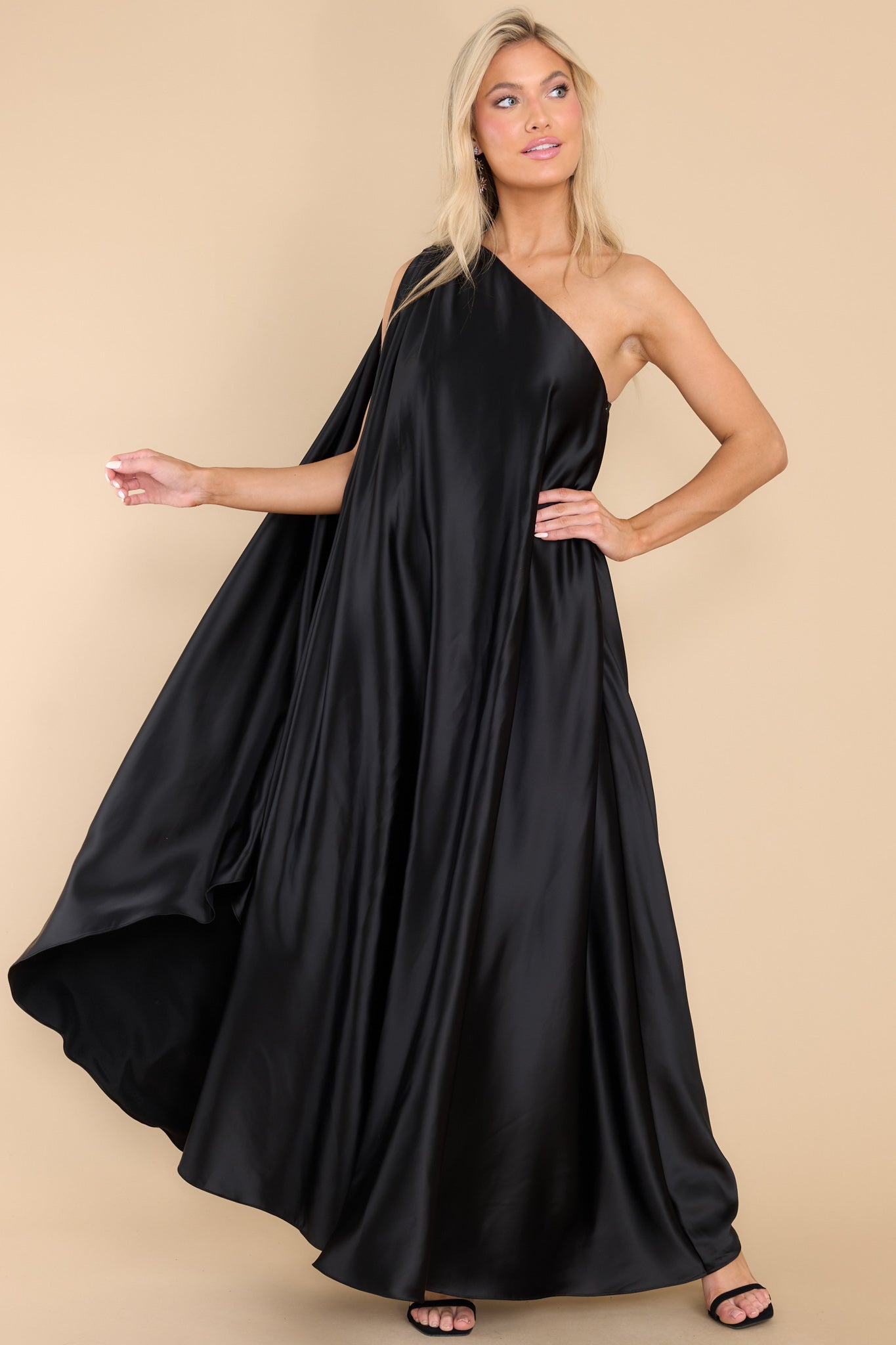 Full body view of this dress that features a hidden one shoulder design, scoop neckline, and open sleeves.