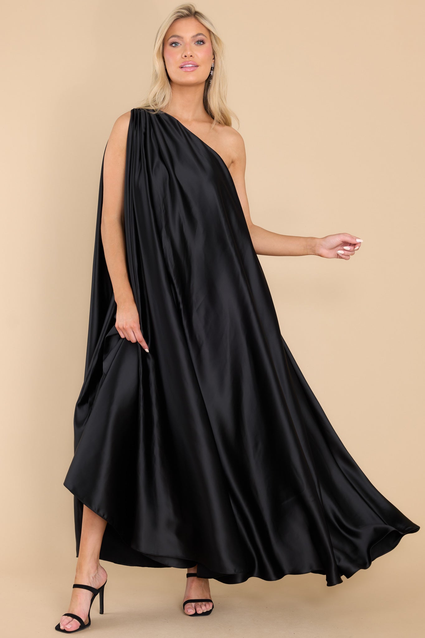 Full body view of this dress that features the asymmetrical neckline that goes over the right shoulder.