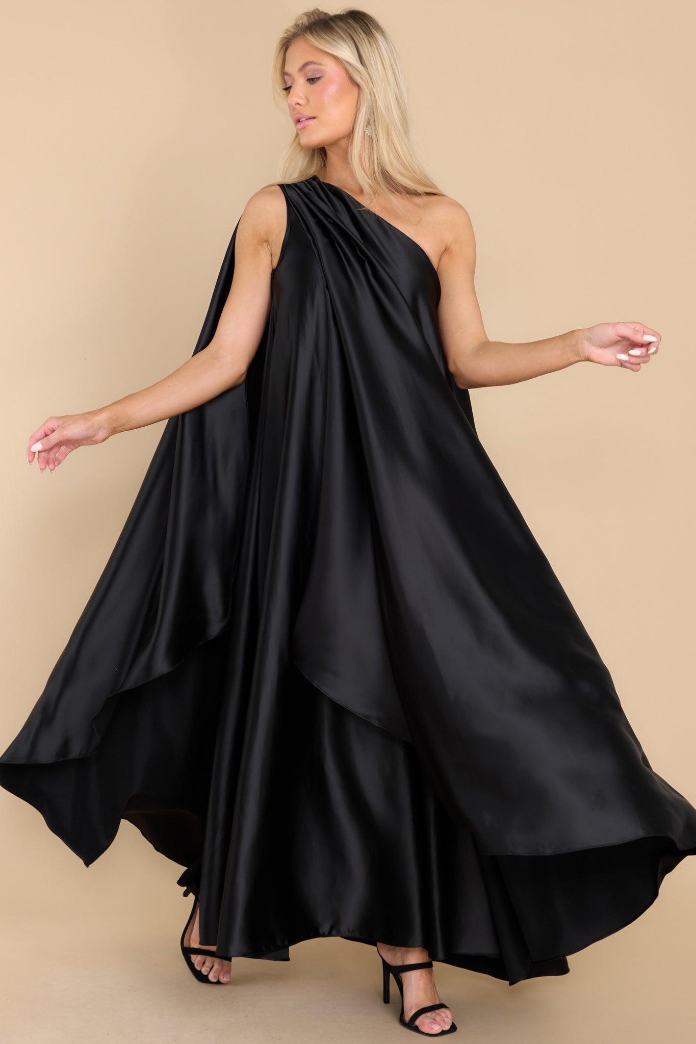 Front view of this dress that features a hidden one shoulder design, scoop neckline, and open sleeves.