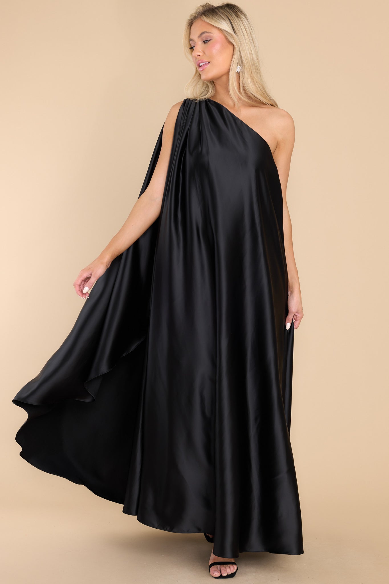 Full body view of this dress that features a hidden one shoulder design and scoop neckline.