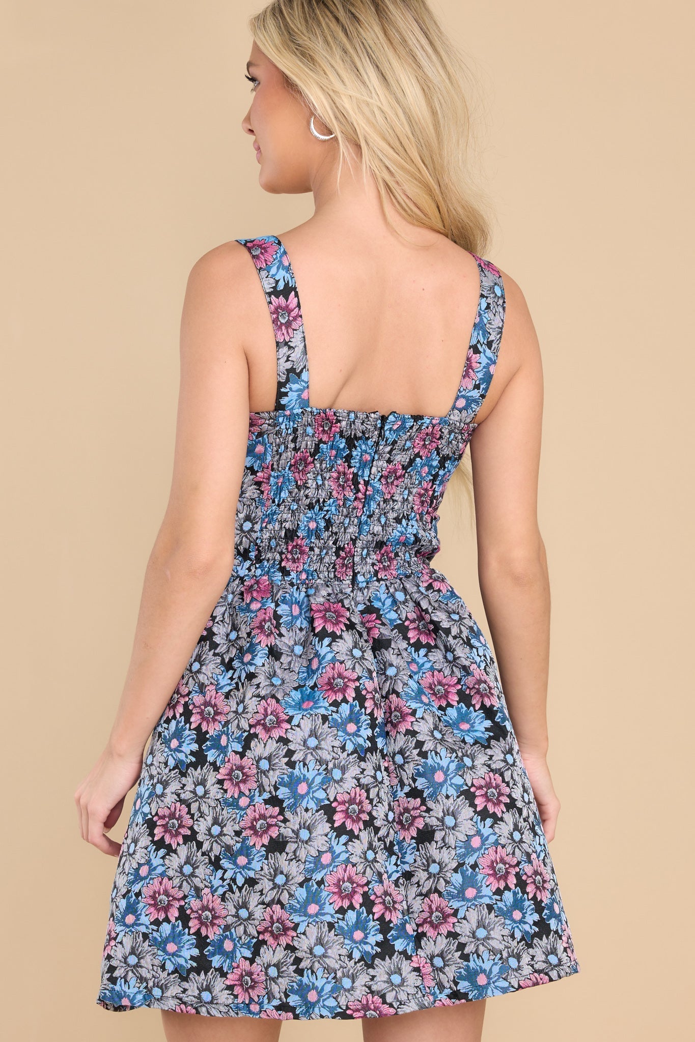 Back view of this dress that features a sweetheart neckline, boning throughout the bust, a smock stretch insert on the back, and a zipper on the back.