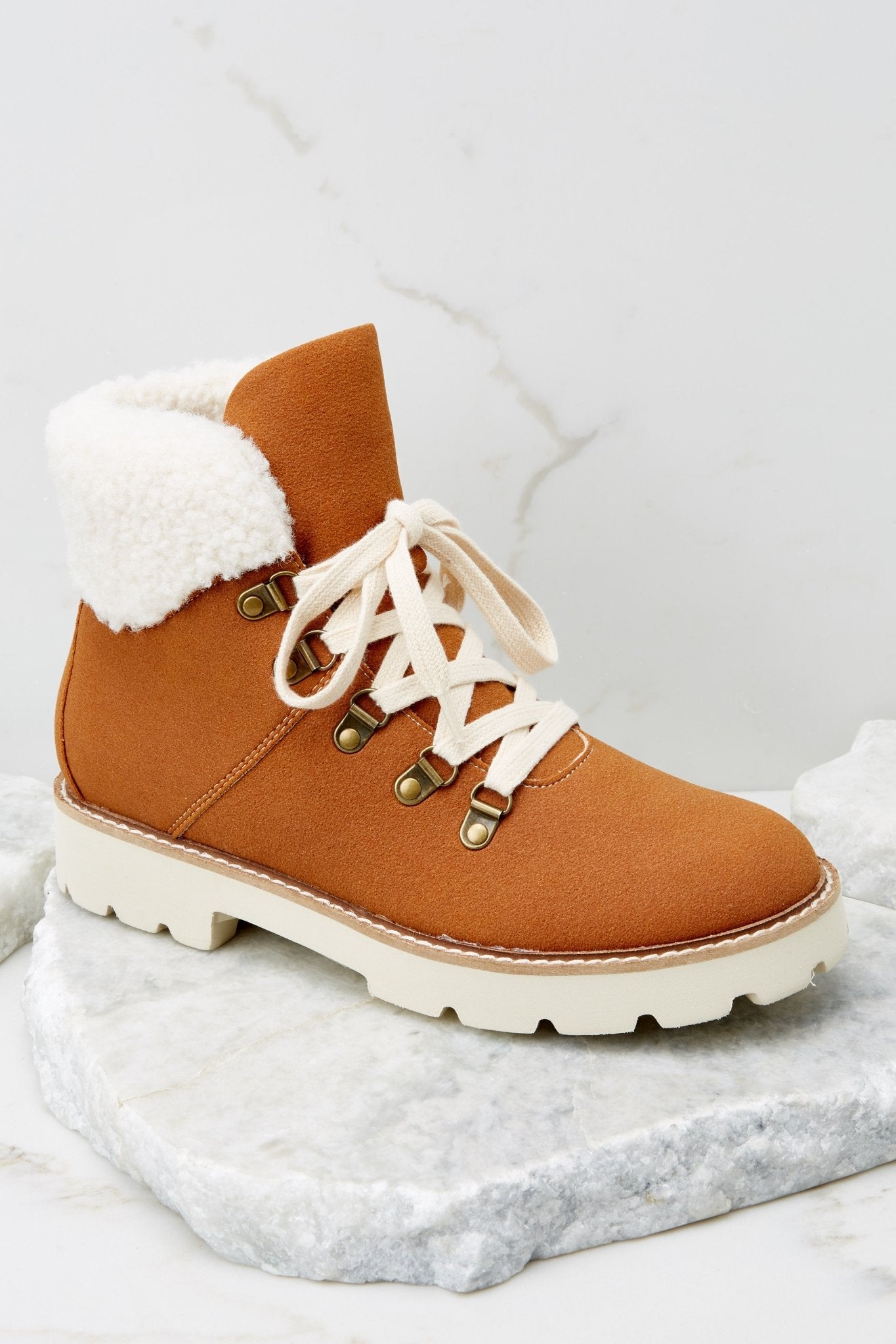 These brown boots feature faux fur around the ankle, a chunky sole and laces up the front.