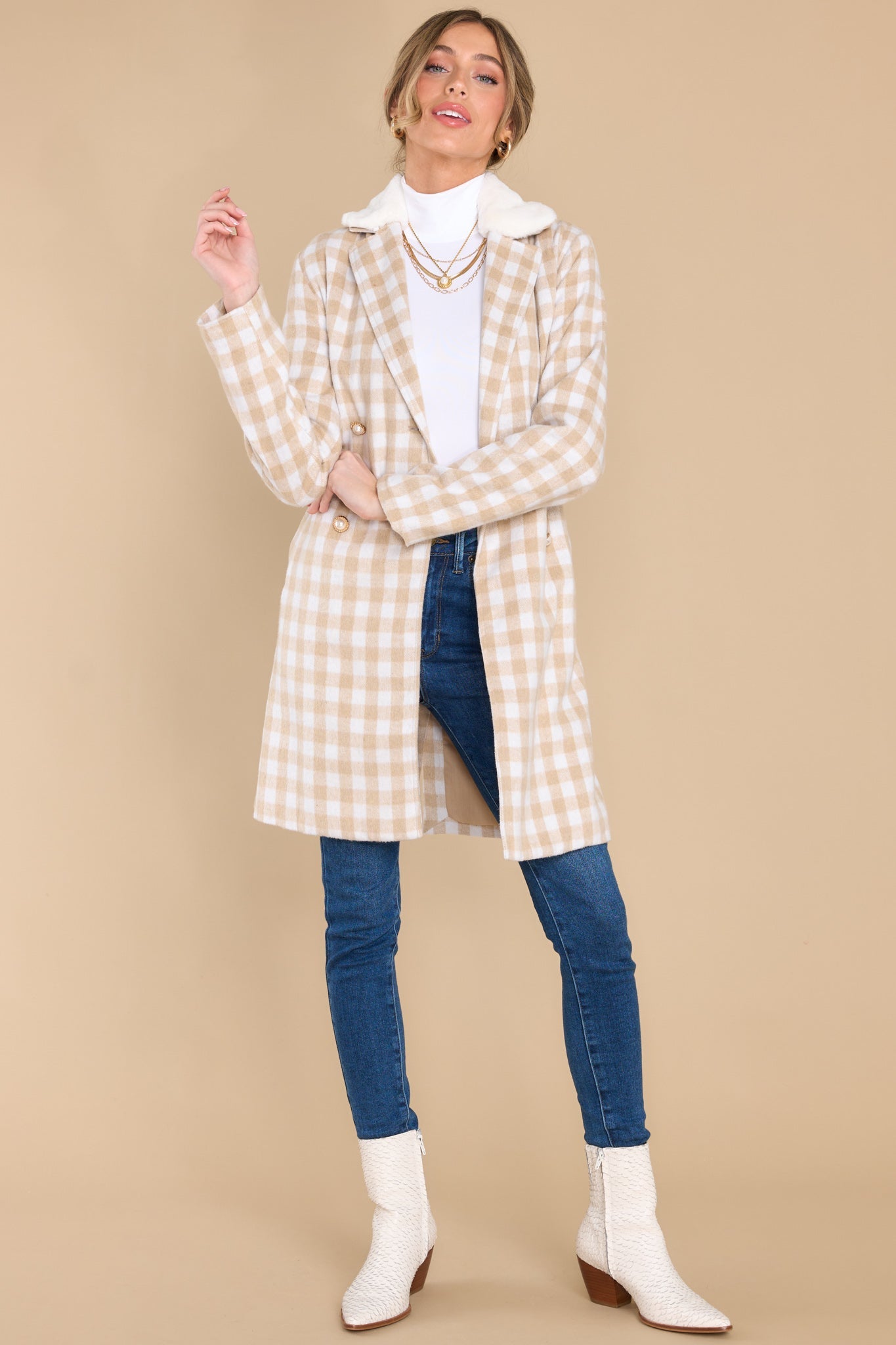 Full body view of this double breasted coat that features an open neckline and a removeable faux fur collar.