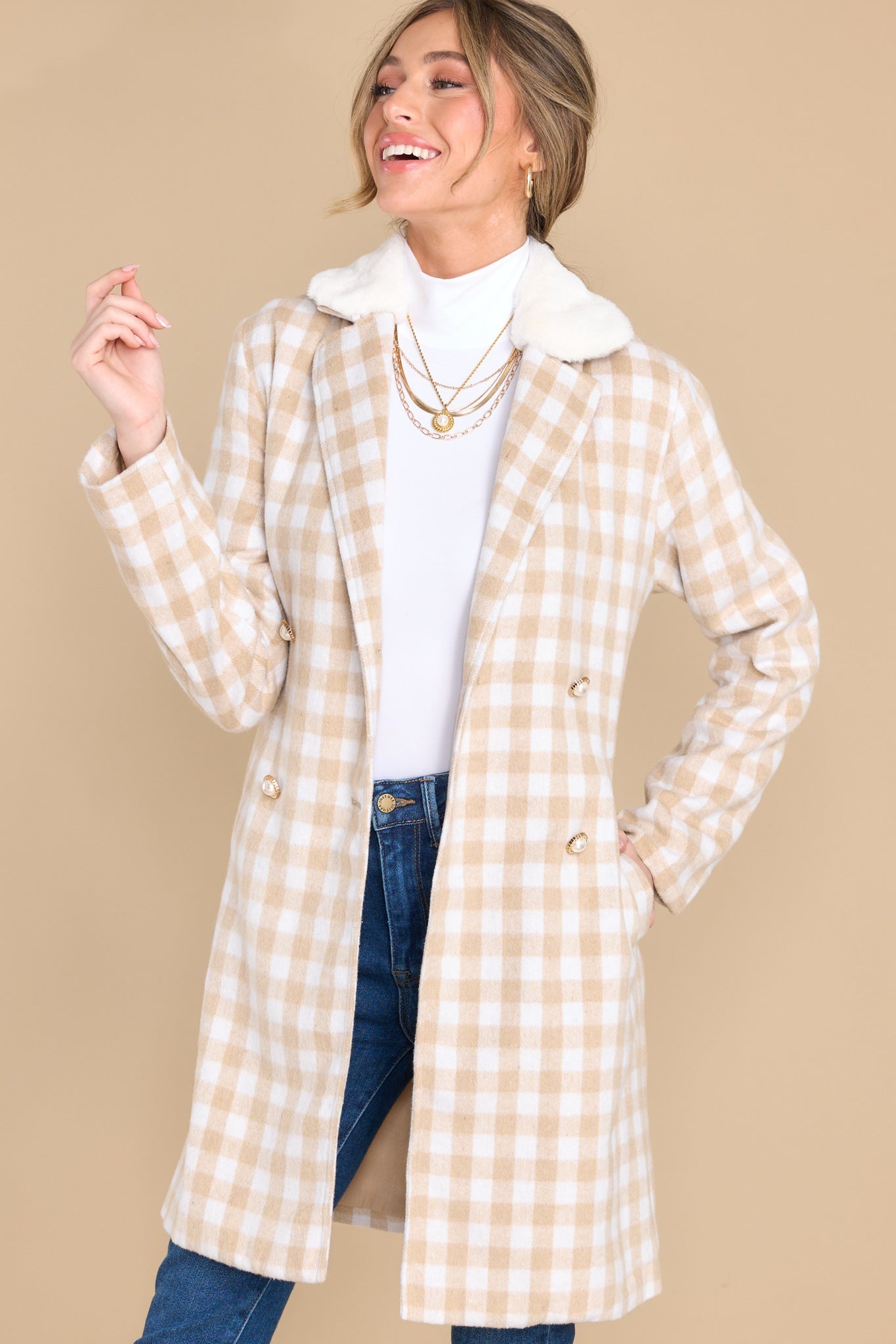 Front view of this double breasted coat that showcases the beige and white plaid pattern.