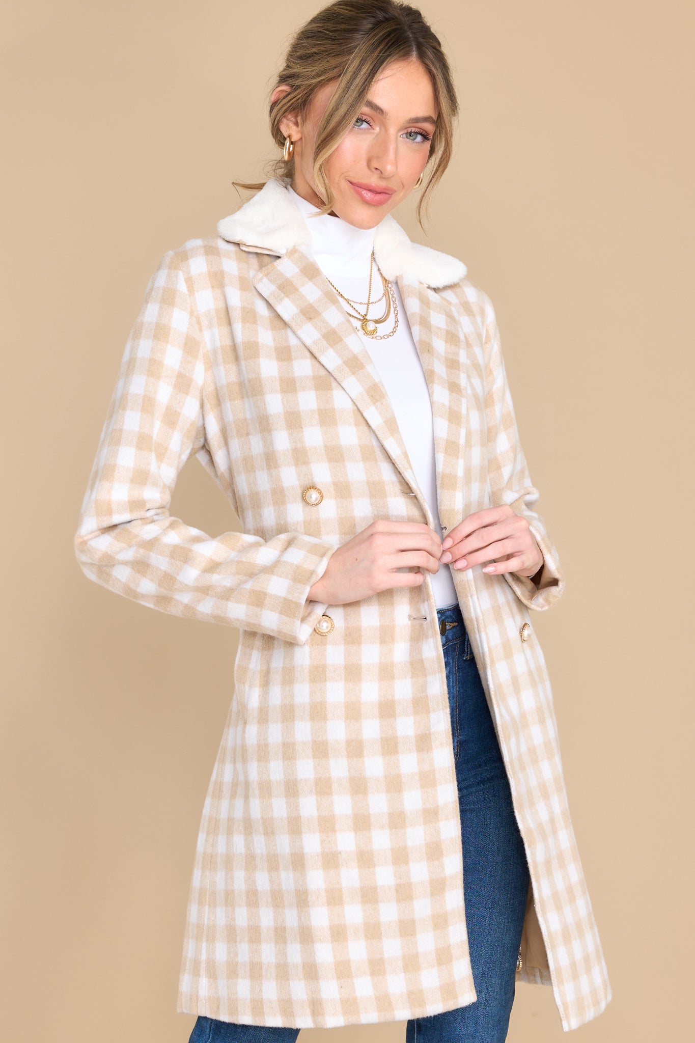 Front view of this double breasted coat that features an open neckline and a removeable faux fur collar.