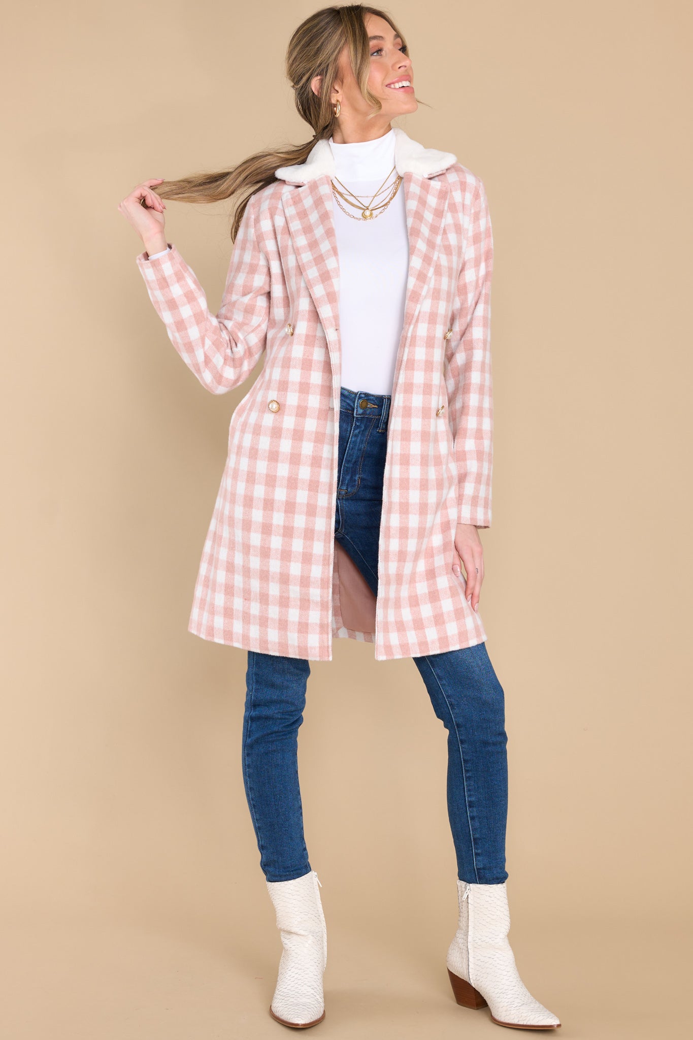 This pink double breasted coat features an open neckline, removeable faux fur collar, a self-tie fabric belt around the waist, and functional waist pockets.
