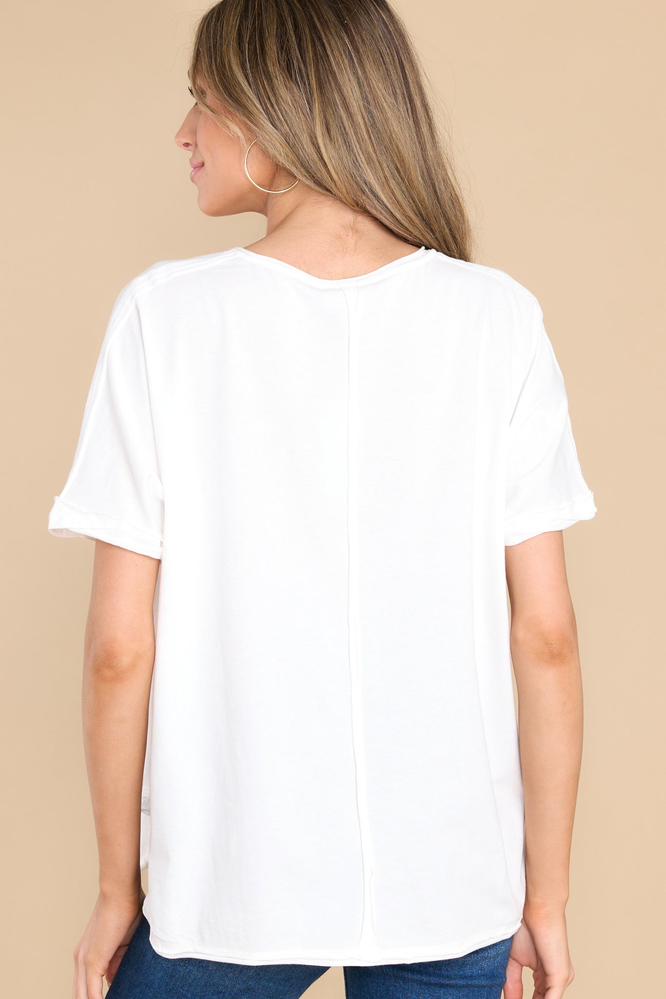 Back view of this top that features an irregular v-neckline leading into a stripe down the middle and the back.