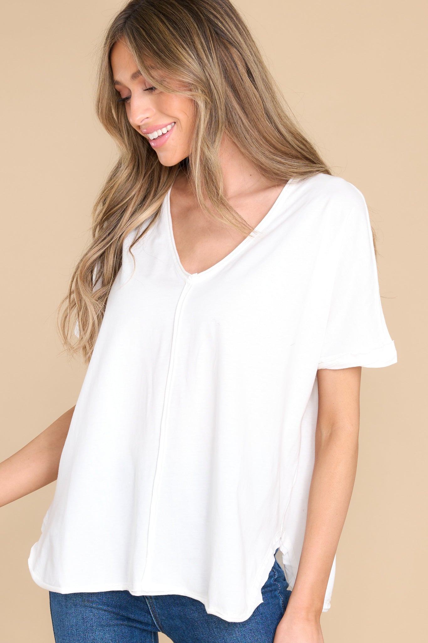 Front view of this top that features an irregular v-neckline leading into a stripe down the middle and the back.