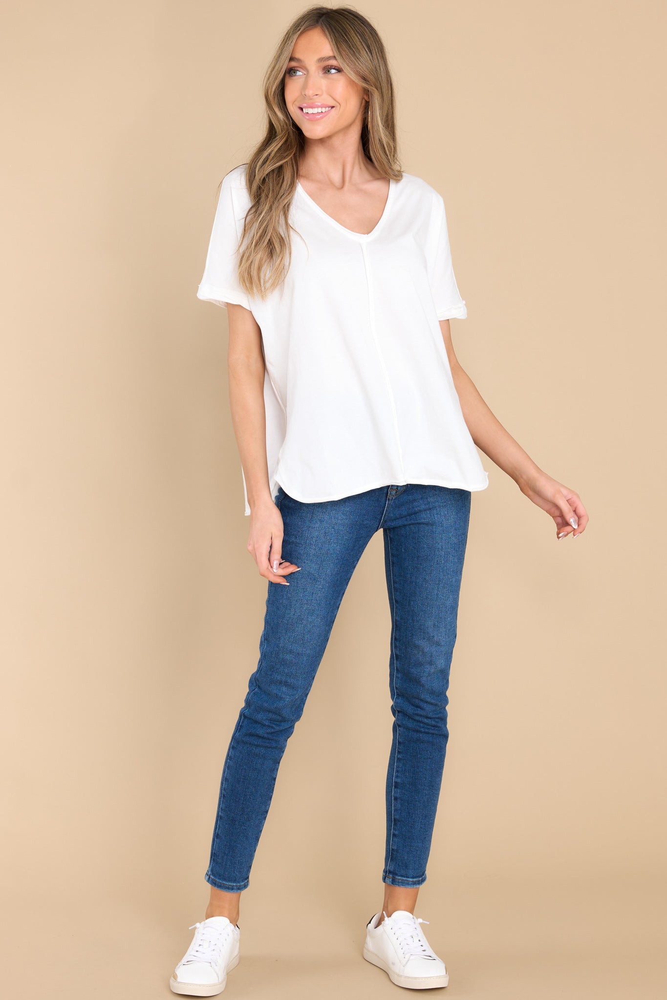 Full body view of this top that features an irregular v-neckline leading into a stripe down the middle and the back.