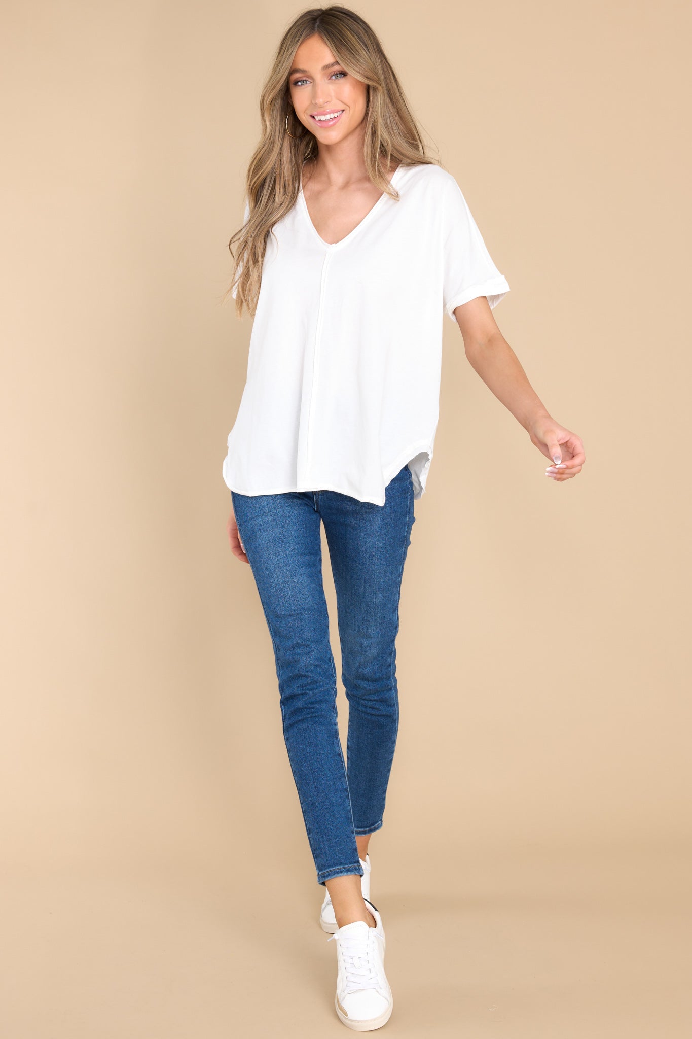 Full body view of this top that features an irregular v-neckline.