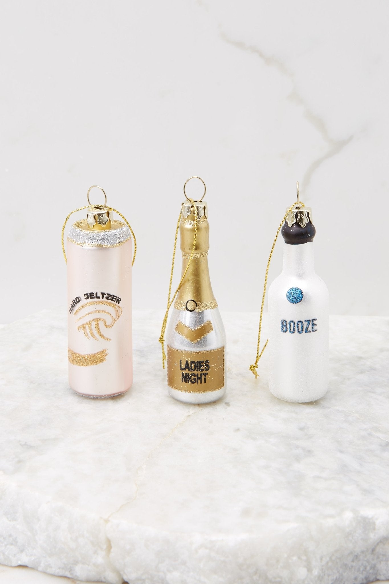 This ornament set features 3 fun bottles with hand painted glitter on them and gold strings.