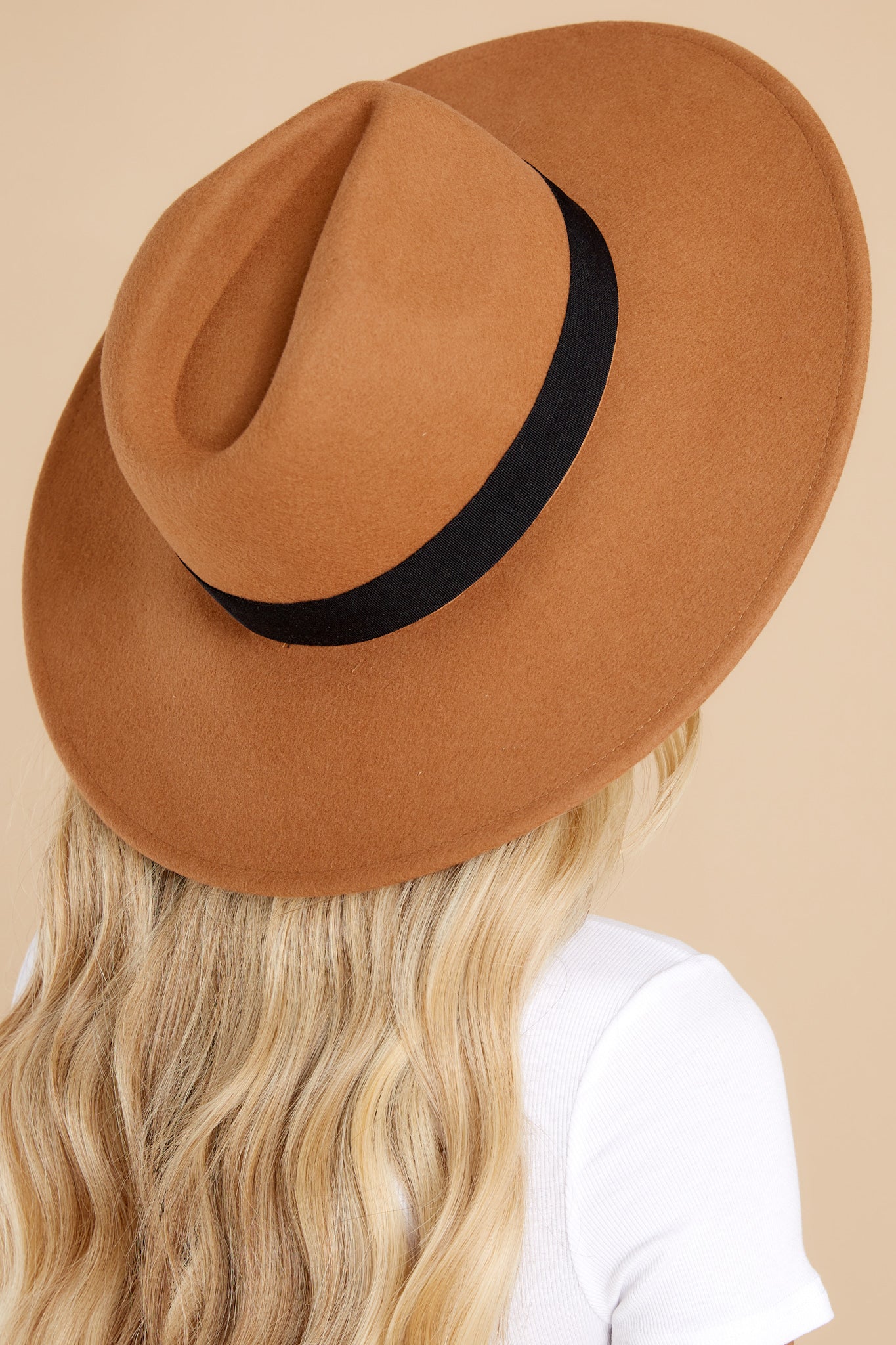 Back view of this wide brimmed hat that features a black ribbon band.